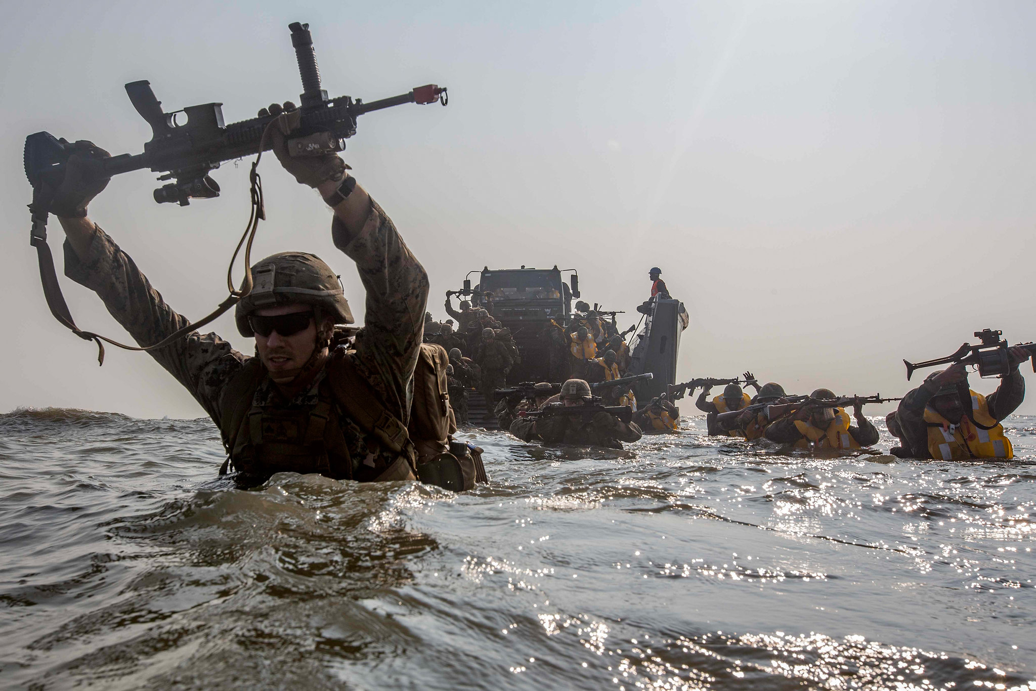 U.S. Marines and members of the Indian military wade to shore Nov. 19, 2019, during exercise Tiger TRIUMPH on Kakinada Beach, India. (Lance Cpl. Christian Ayers/Marine Corps)