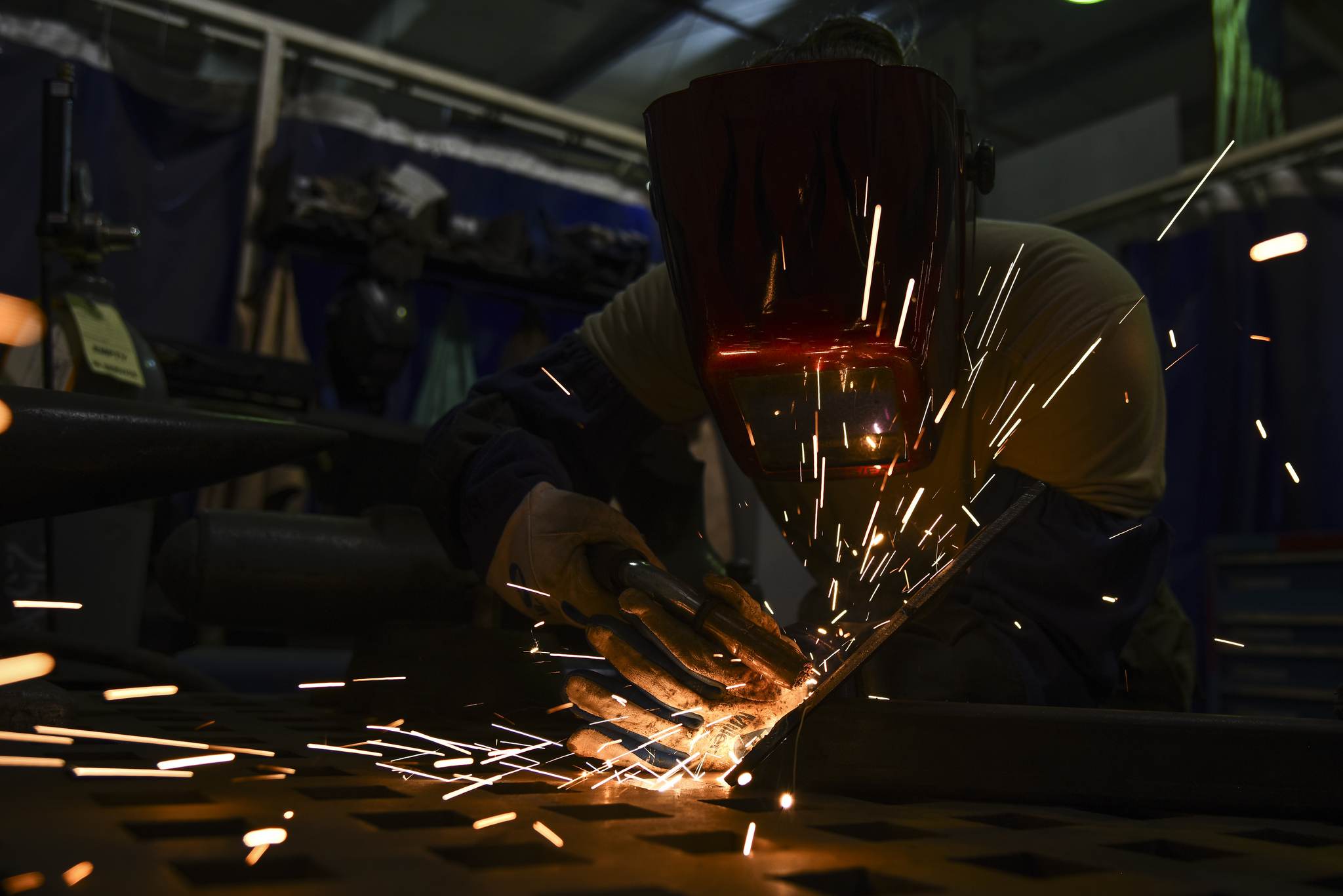 Senior Airman Courtnee Grafton, 380th Expeditionary Maintenance Squadron metal technician, welds a piece of metal at Al Dhafra Air Base, United Arab Emirates, Dec. 9, 2018. The 380th EMXS fabrication flight is in charge of identifying and repairing aircraft structural damage. (Senior Airman Mya M. Crosby/Air Force)