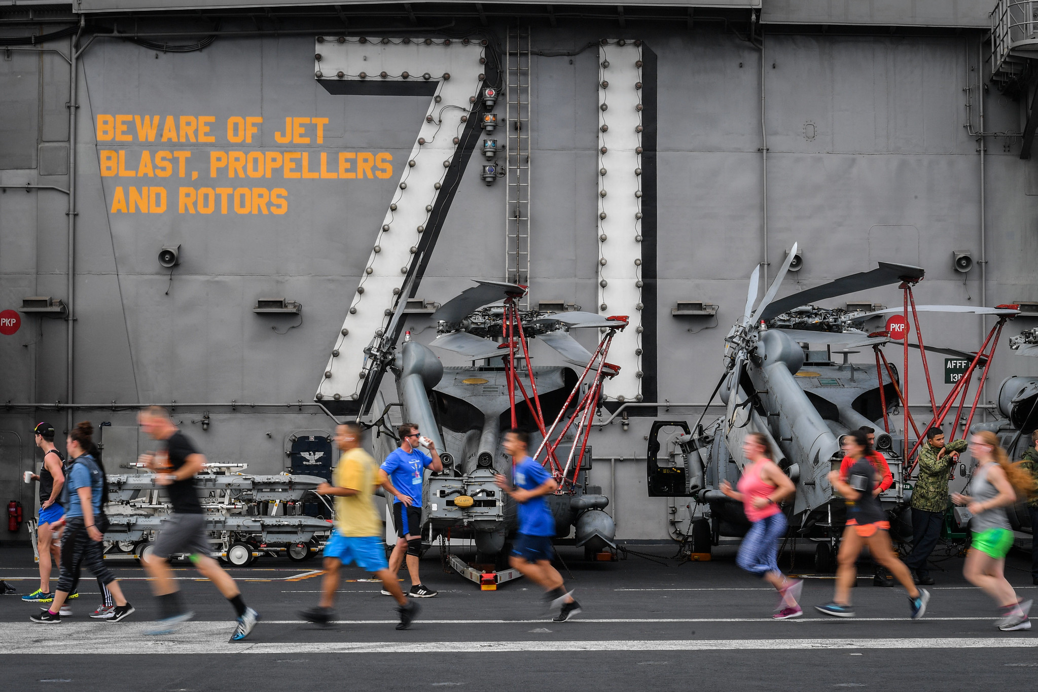 Sailors run during a Summer Sun 5K on the flight deck of the aircraft carrier USS Theodore Roosevelt (CVN 71) on July 21, 2019. (Mass Communication Specialist Seaman OIympia O. McCoy/Navy)