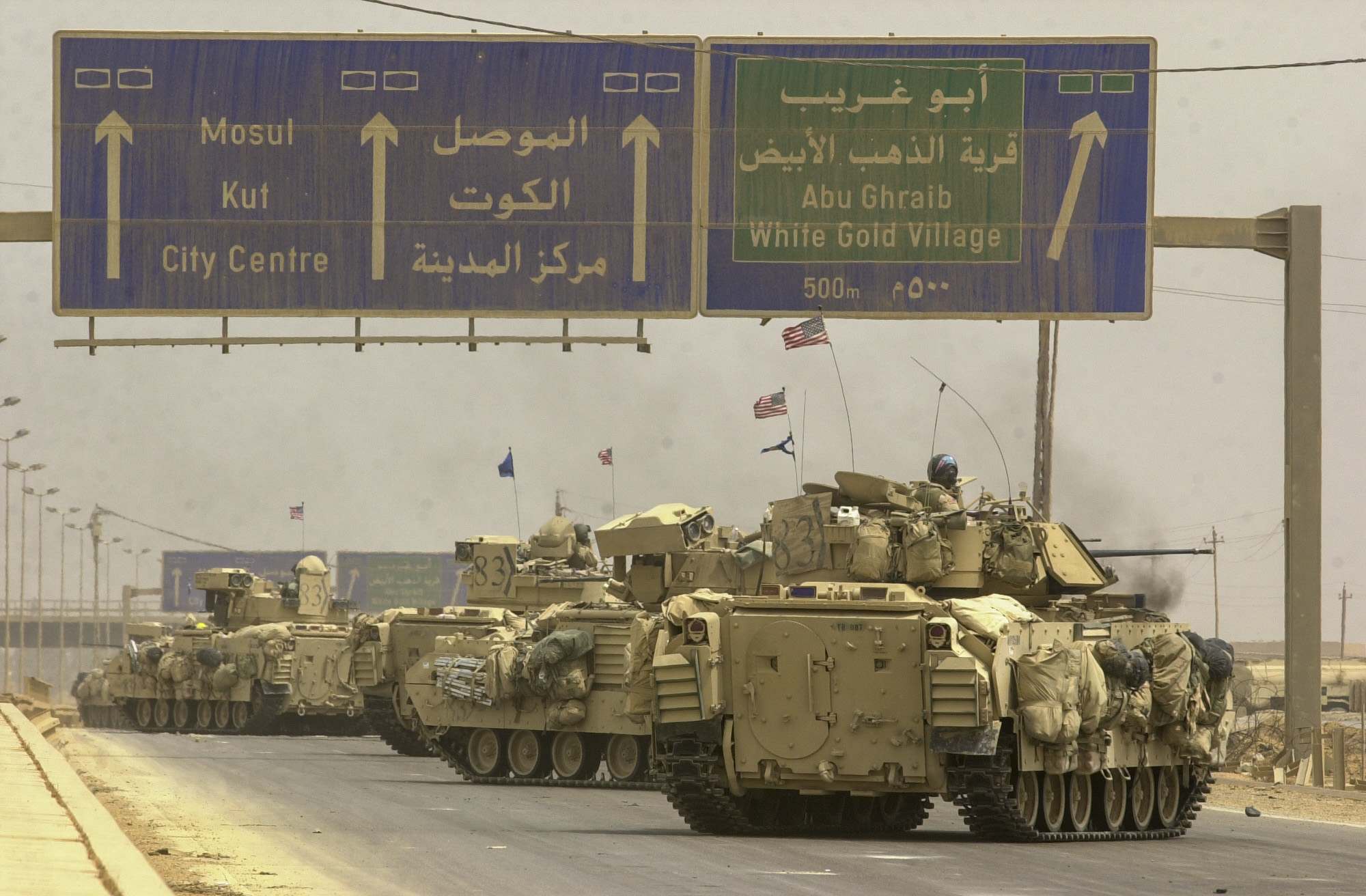 Vehicles from the U.S. Army's 3rd Infantry Division, 3rd Brigade rumble along an access road to highway 10 enroute to the Northwestern side of the city, to complete the encirclement of Baghdad. The 3rd Squadron, 7th Cavalry Regiment has had some fierce fighting on highway 10 over the last two days, killing close to 1000 Iraqi soldiers in vehicles ranging from tanks to buses loaded with explosives. The Cavalry's job was to secure the highway and allow safe pasage of the rest of the 3rd Brigade. (Warren Zinn/Army Times)