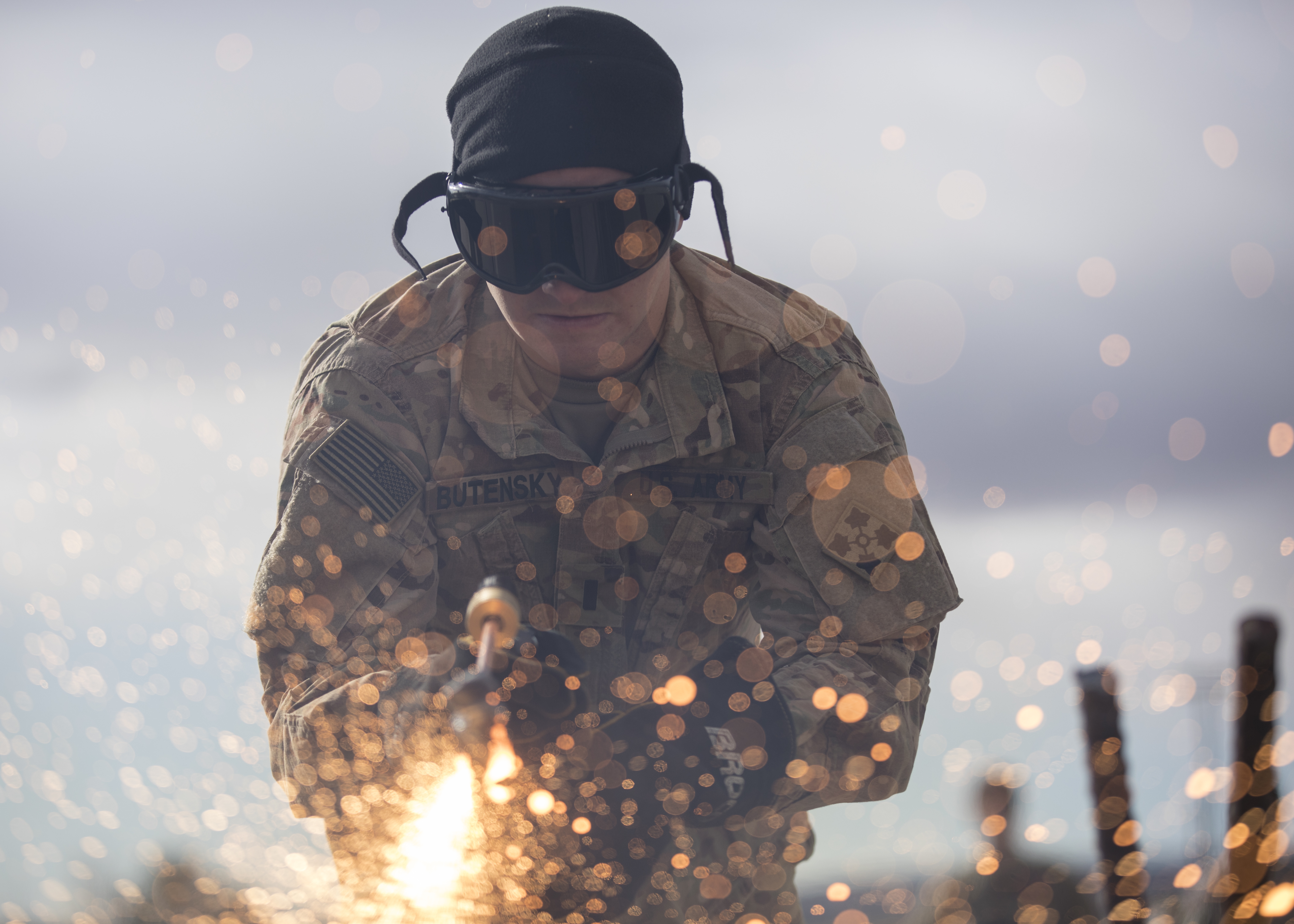 1st Lt. Daniel Butensky, an engineer officer assigned to 299th Brigade Engineer Battalion, 1st Stryker Brigade Combat Team, 4th Infantry Division, cuts through metal with a Broco torch in sub-freezing temperatures during the Best Sapper Competition, Fort Carson, Colorado, December, 6, 2017. U. S. Army photo by Sgt. Micah Merrill
