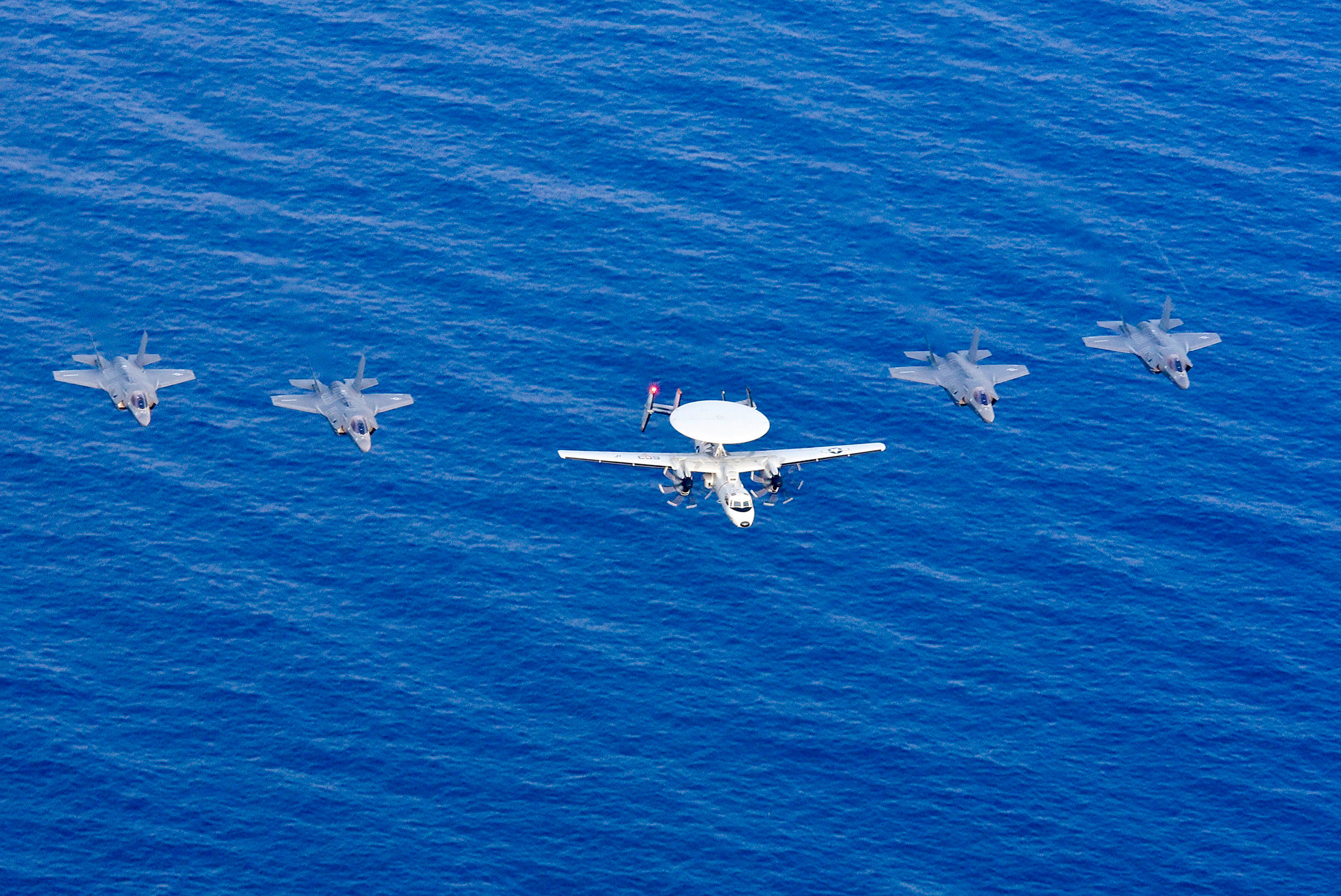 An E-2D Hawkeye and four F-35 Lightning II aircraft fly in formation April 8, 2019, after flying over the amphibious assault ship USS Wasp (LHD 1) during Exercise Balikatan 2019 in the South China Sea. (Mass Communication Specialist 3rd Class Benjamin F. Davella III/Navy)