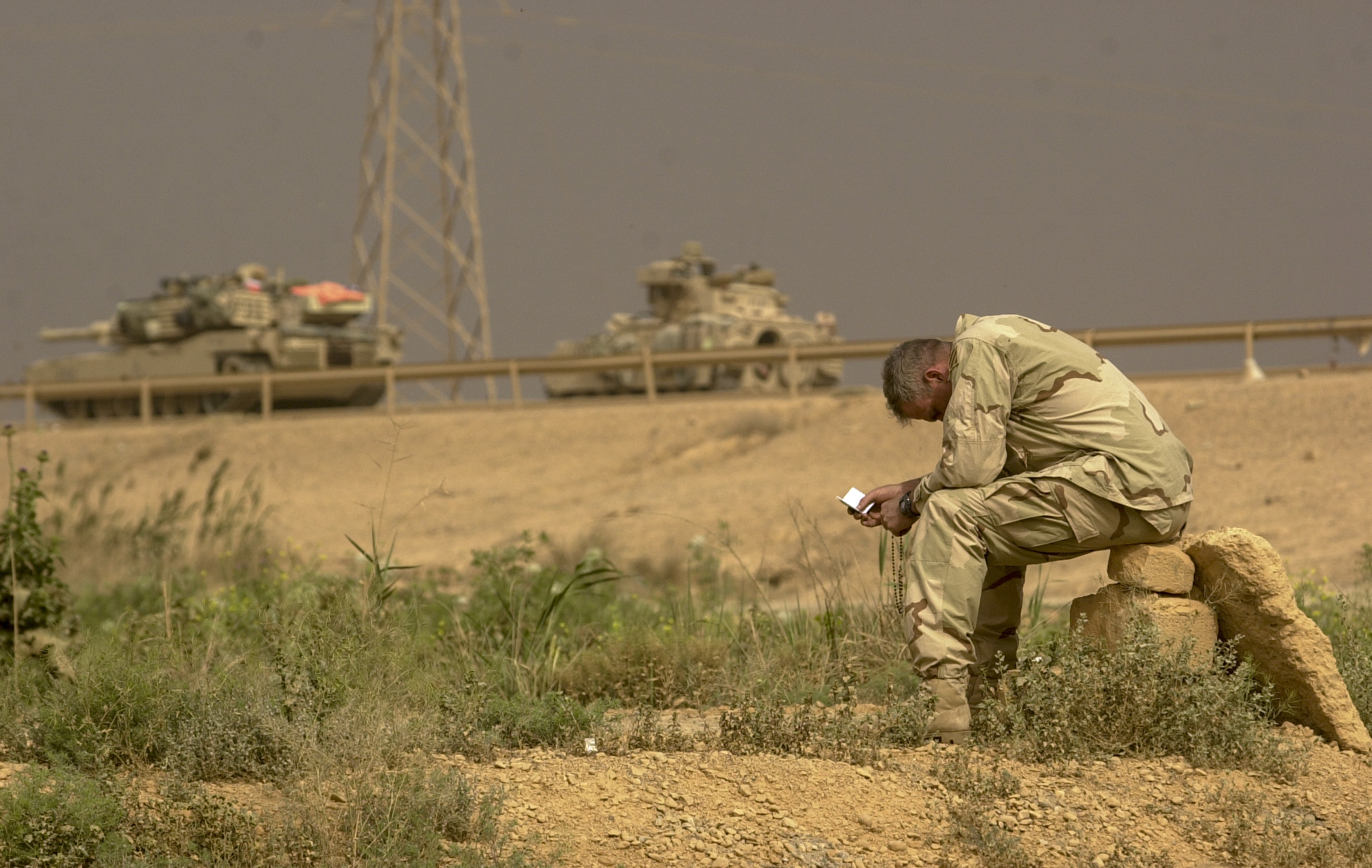 Cpt. Bill Brown, 34 of Savannah, Ga takes advantage of a pause in action to find a quiet place to pray. Brown is with the U.S. Army's 3rd Squadron, 7th Cavalry Regiment. The Cavalry is currently holding a blocking position in the south of Baghdad to control all traffic moving in and out of the city. (Warren Zinn/Army Times)