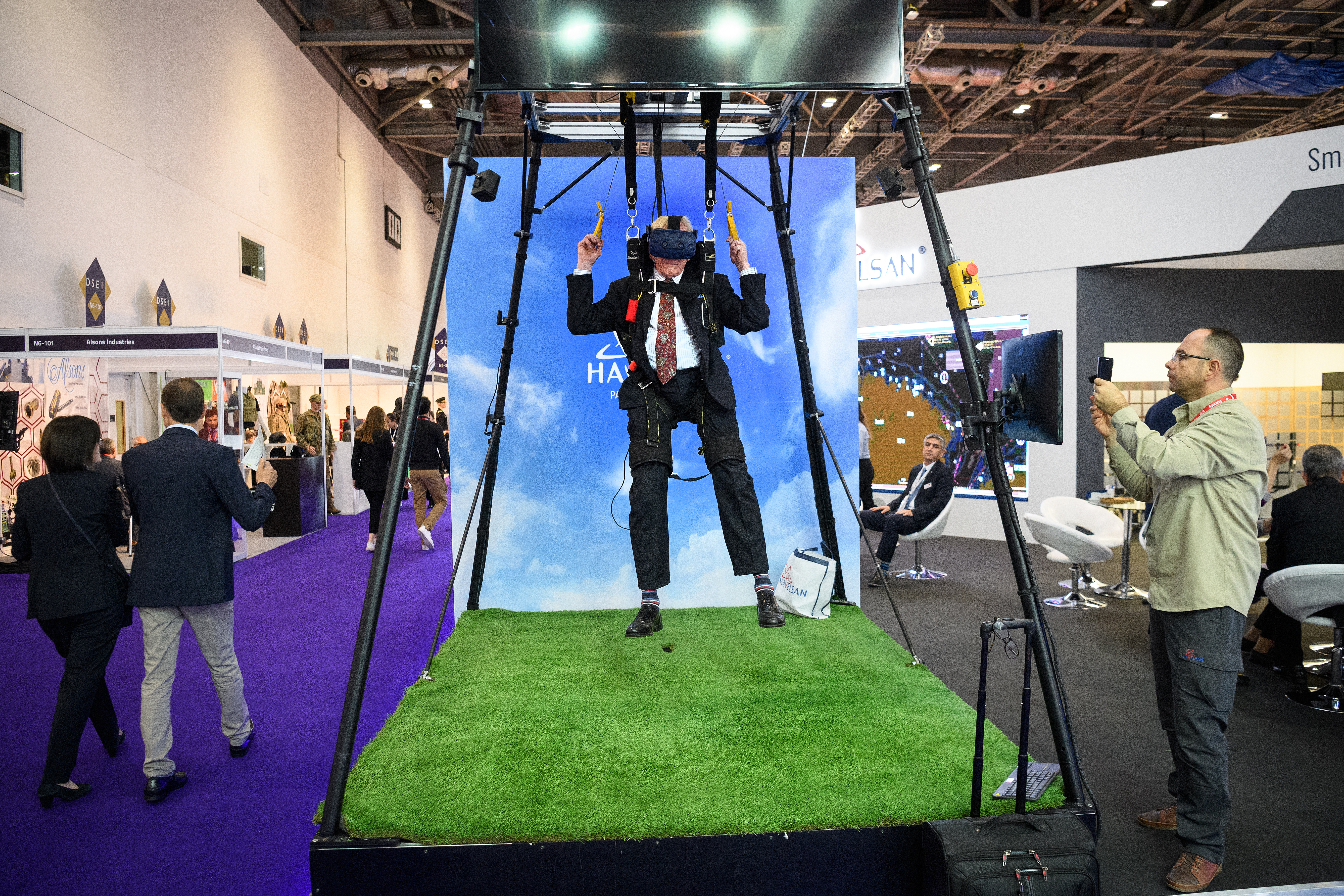 A delegate experiences a virtual parachute jump on the Havelsan display stand on the second day of the DSEI arms fair. (Leon Neal/Getty Images)