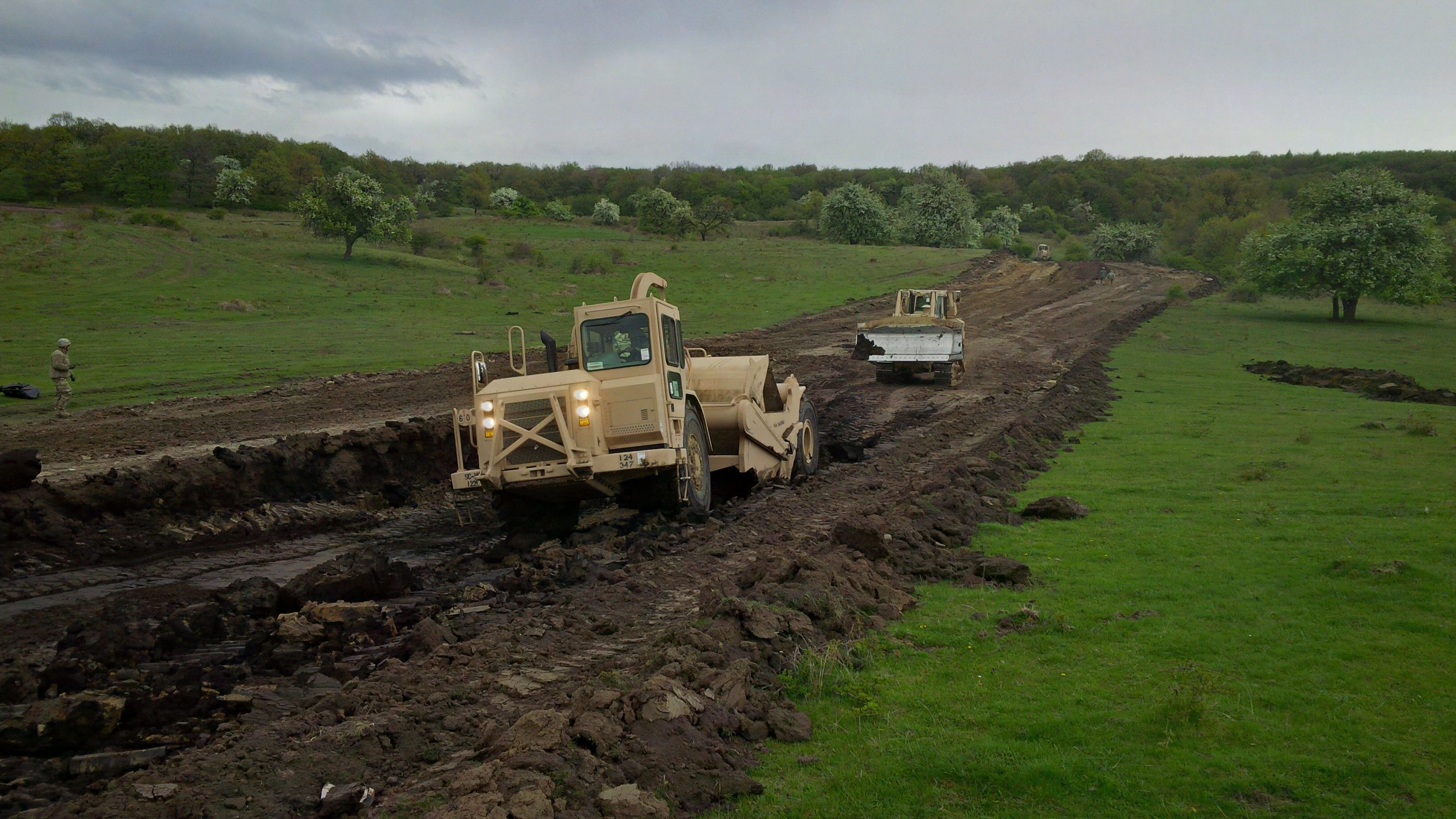 A scraper removes dirt from lane two near battle position two of the nonstandard live fire range. The area needed to be firmed up, so the soft material was excavated and backfilled with better material to solidify the surface. (Jen Judson/Staff)