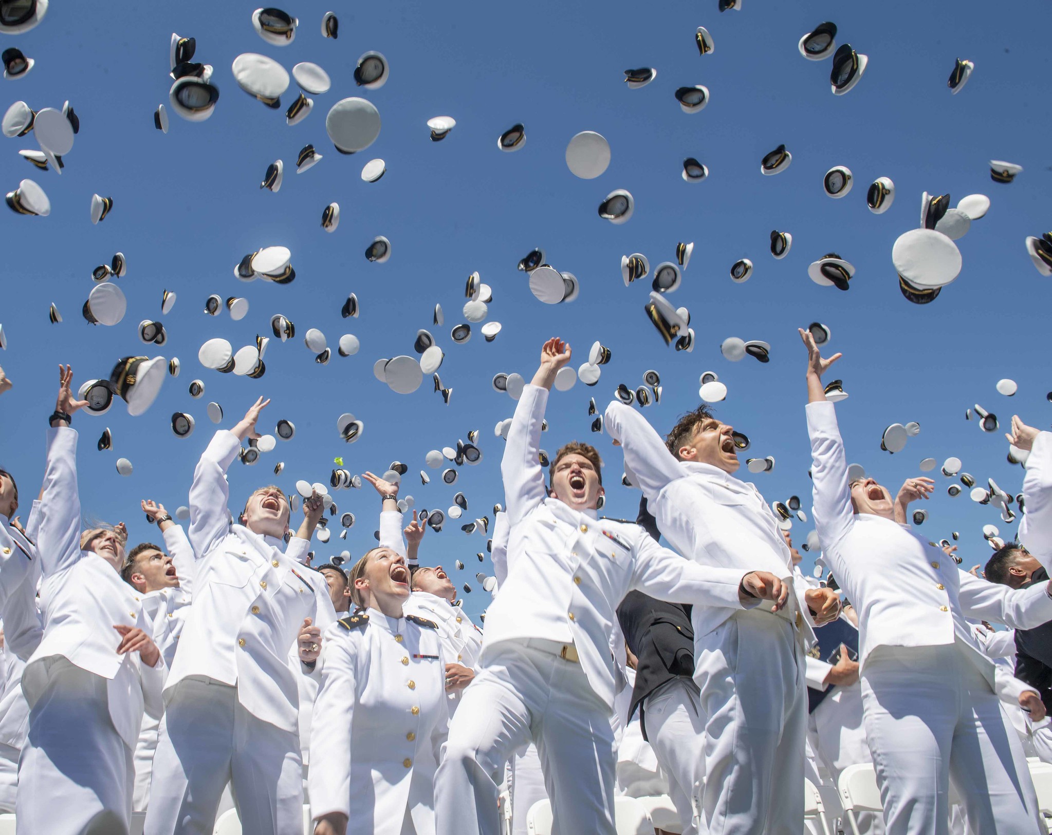 Midshipmen toss their covers in the air during the United States Naval Academy's Class of 2019 Graduation Day and Commissioning Ceremony on May 24, 2019 in Annapolis, Md. (Mass Communication Specialist 3rd Class Josiah D. Pearce/Navy)