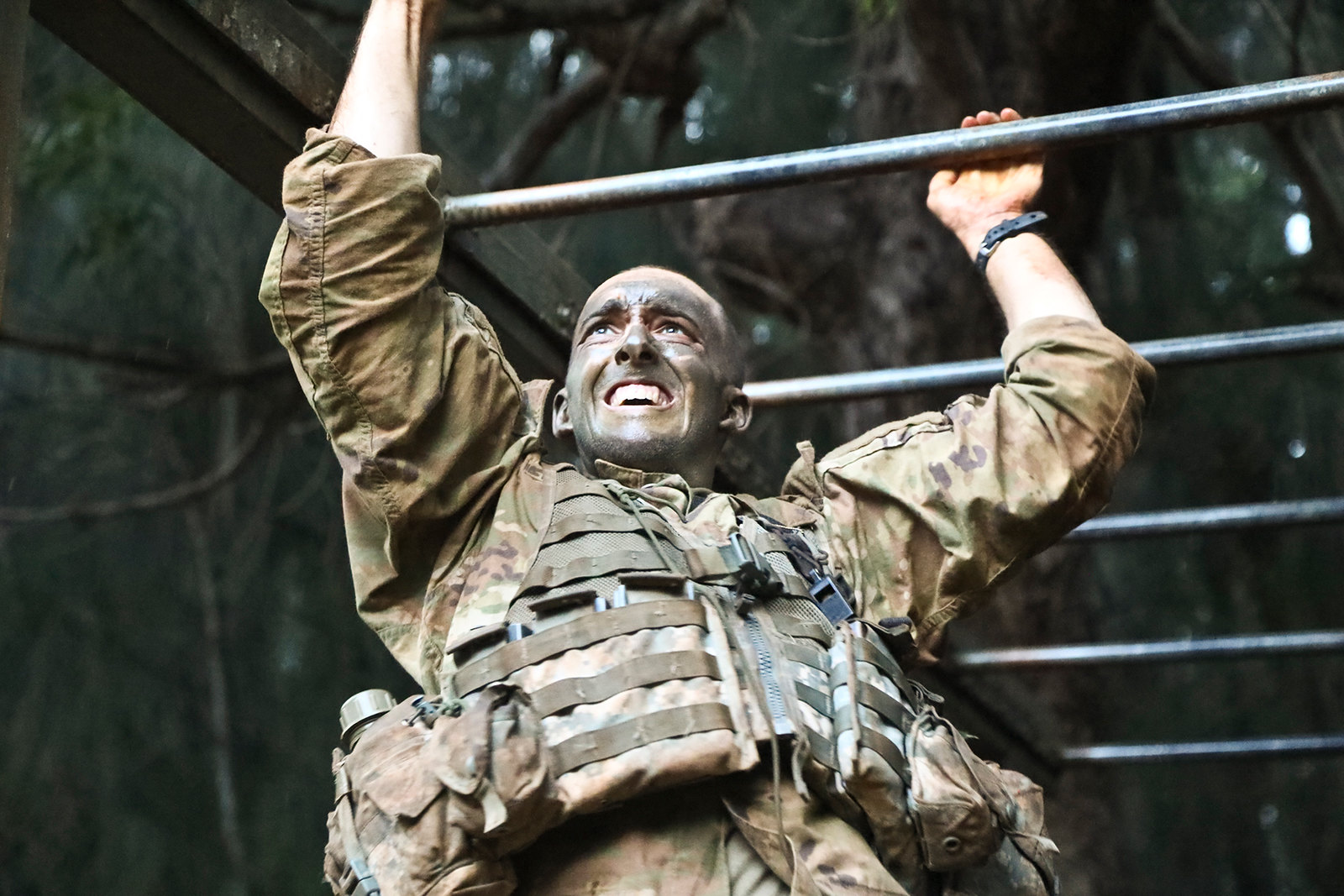 A soldier scales the monkey bars as part of the Green Mile physical endurance course during jungle training at Lightning Academy in Wahiawa, Hawaii, April 18, 2019. (Spc. Valencia McNeal/Army)