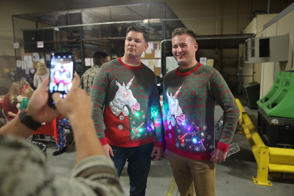 Marines with I Marine Expeditionary Force Information Group show off their light-up Christmas sweaters at a holiday party held by I MIG at Camp Pendleton, Calif., Dec. 14, 2017. (Lance Cpl. Robert Bliss/Marine Corps)