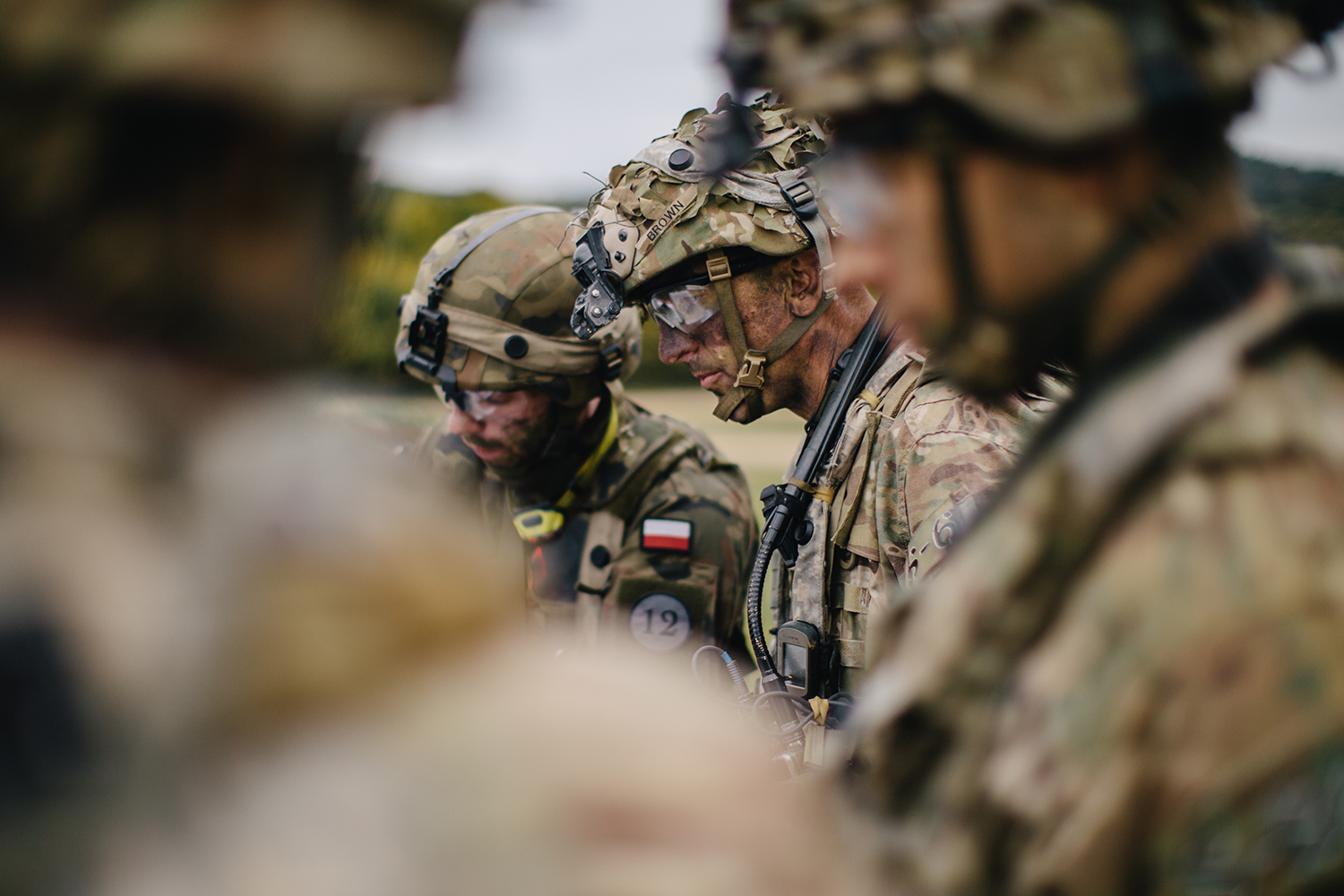 Lt. Col. Joshua Brown, the commander of 1st Squadron, 91st Cavalry Regiment, 173rd Airborne Brigade, discusses and plans upcoming operations alongside his company commanders and officers of the 2nd Battalion, 12th Brigade Polish Army in Hohenfels Training Area, Germany during Saber Junction 19 on Sept. 27, 2019. (Spc. Ryan Lucas/Army)