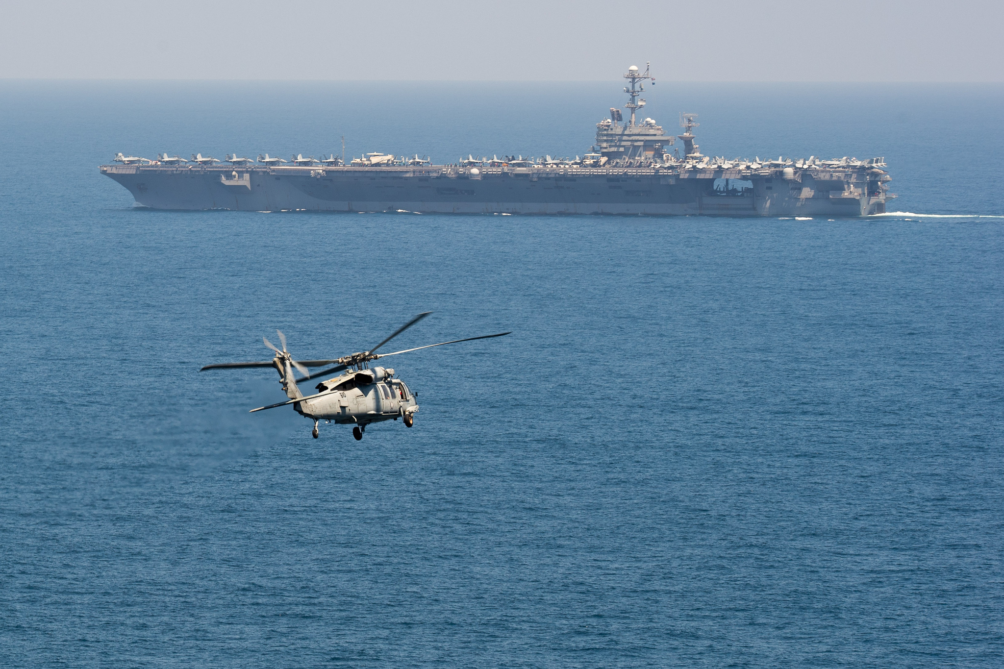 An MH-60S Sea Hawk helicopter flies toward the aircraft carrier USS John C. Stennis (CVN 74) on March 16, 2019, in the Indian Ocean. (Mass Communication Specialist 3rd Class Grant G. Grady/Navy)