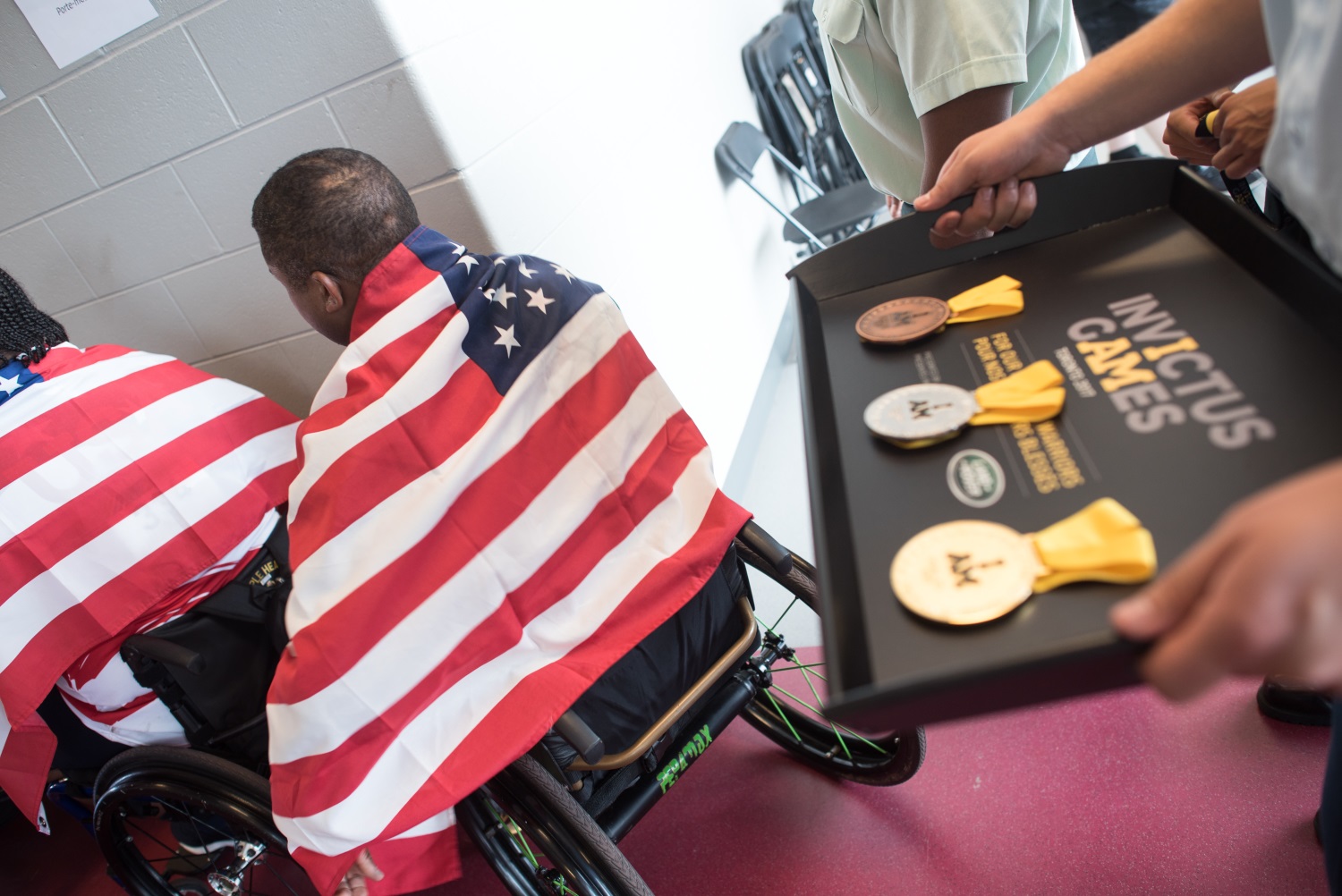 Several U.S. athletes prepare to receive medals at the 2017 Invictus Games at the York Lions Stadium in Toronto, Canada, on Sept. 24, 2017. More than 550 wounded, ill and injured servicemen and servicewomen from 17 allied nations are expected to compete. (Sgt. James K. McCann/DoD)