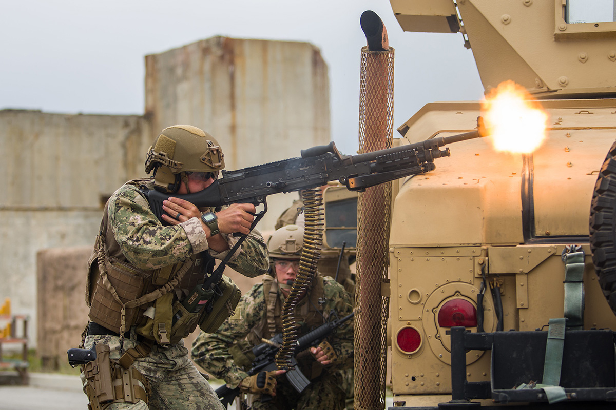 Engineman 2nd Class Christian McCain engages opposing forces while dismounted with an M240 machine gun on June 14, 2019, as the Coastal Riverine Squadron 1 convoy section is assessed at Naval Air Station Point Mugu, Calif. (Hospital Corpsman 1st Class Kenji Shiroma/Navy)