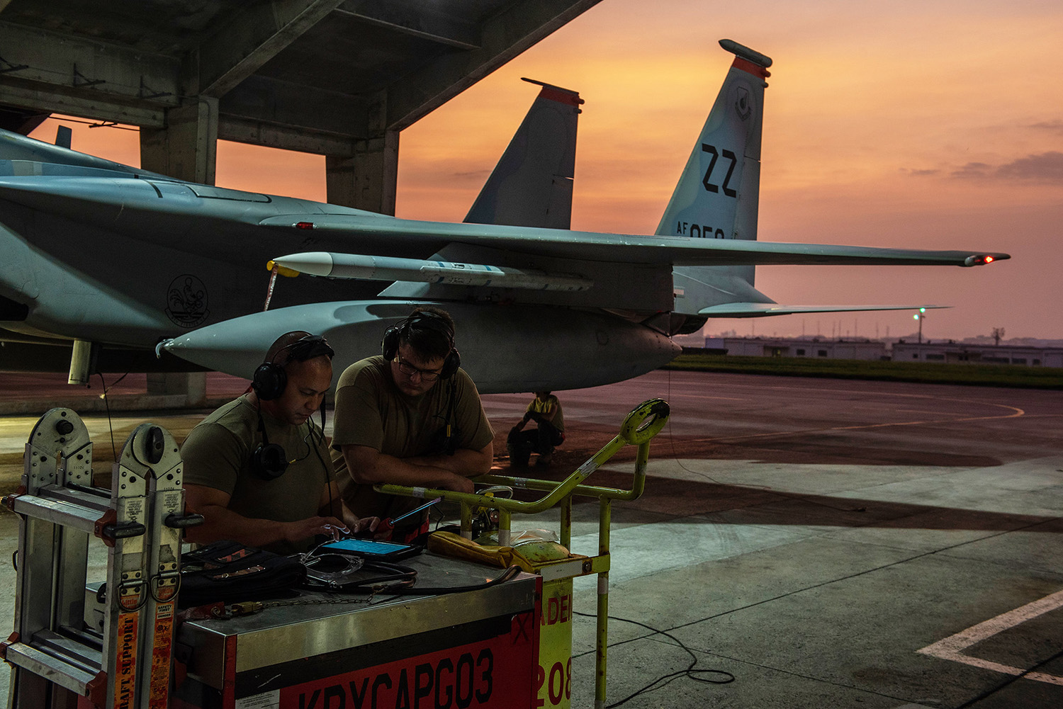 Crew chiefs assigned to the 18th Aircraft Maintenance Squadron discuss the preparation requirements for a 67th Fighter Squadron F-15C Eagle before a mission at Kadena Air Base, Japan, Sept. 16, 2019. (Tech. Sgt. Matthew B. Fredericks/Air Force)