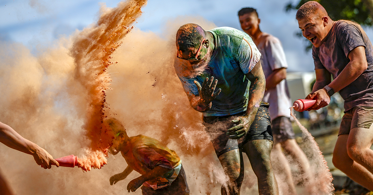 Runners get sprayed with colored powder during the 1st Battalion, 3rd Marine Regiment (1/3) 5K Color Dash, aboard Marine Corps Base Hawaii, Aug. 18, 2018. U.S. Marines with 1/3, held a 5K Color Dash where volunteers showered racers with colored powder while also giving participants a scenic route near Fort Hase Beach. (Sgt. Aaron S. Patterson/Marine Corps)