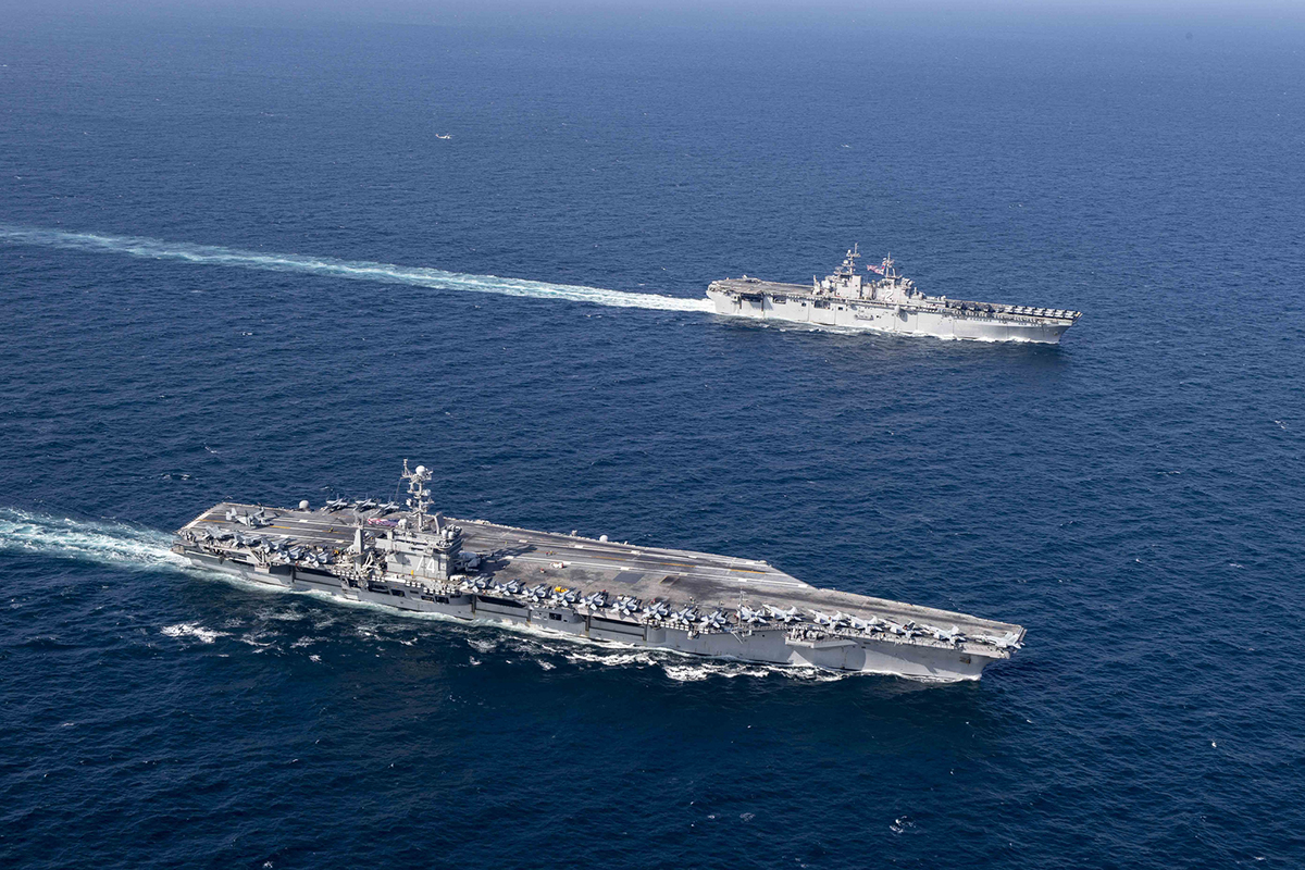 USS John C. Stennis (CVN 74) and the amphibious assault ship USS Essex (LHD 2) sail in formation on Dec. 14, 2018, in the Arabian Sea. (MC3 Connor D. Loessin/Navy)