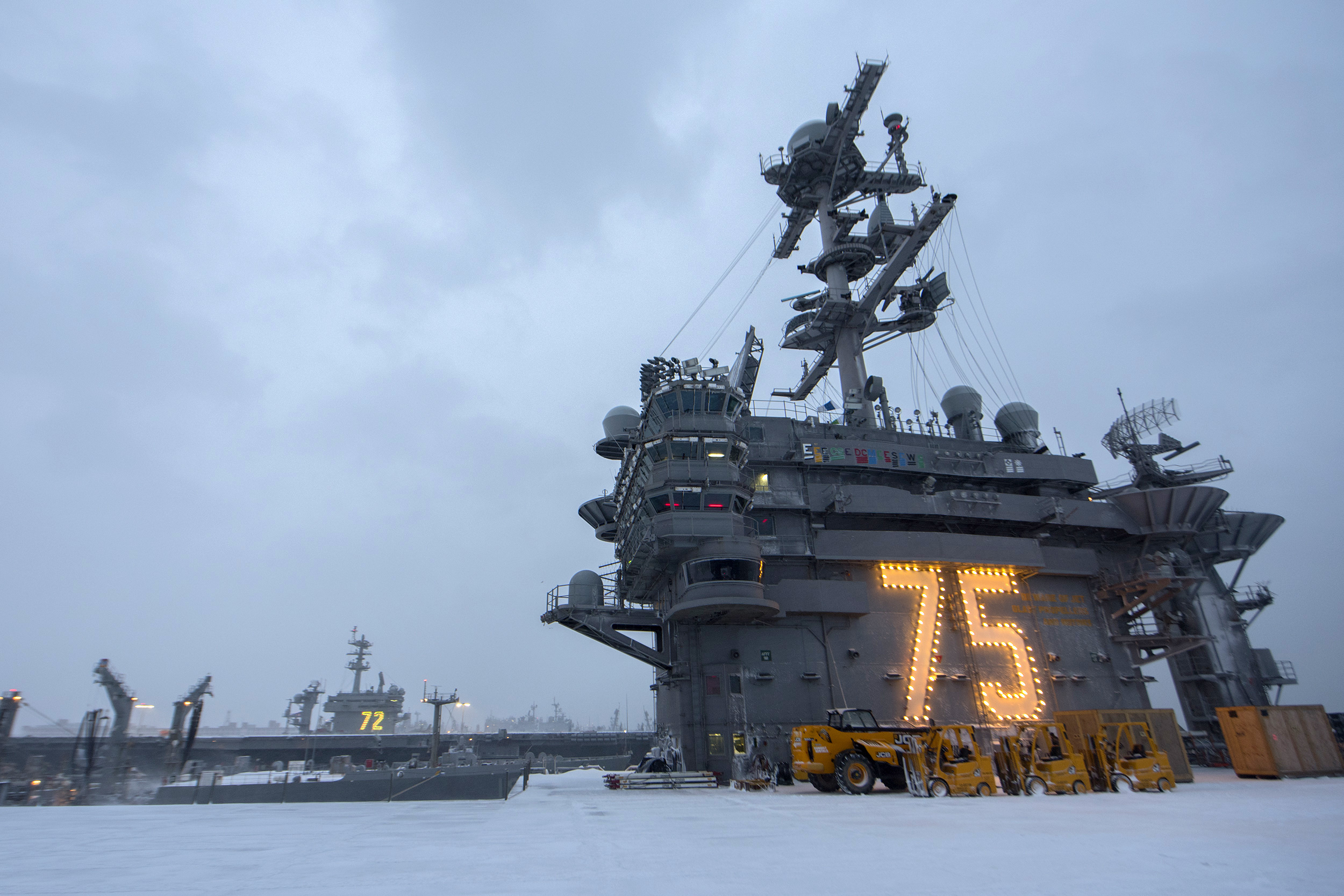 The aircraft carriers USS Harry S. Truman and USS Abraham Lincoln are blanketed with snow following blizzard-like conditions. (Scott Swofford/Navy)