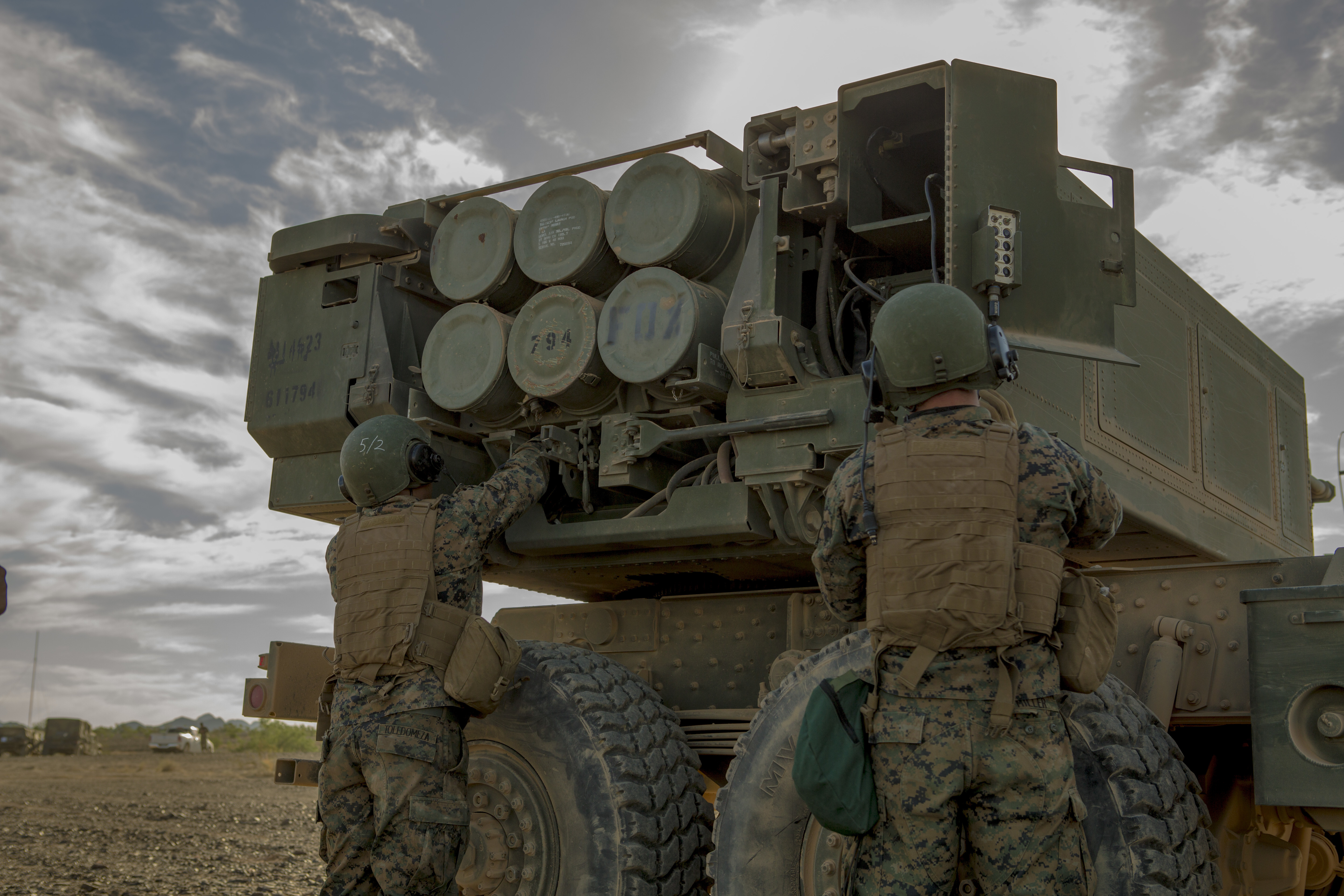 Sgt. Manuel Toledomeza (left), a section chief, and Lance Cpl. Anthony Miller, a gunner, both with 3rd Platoon, Rocket Battery F, 2nd Battalion, 14th Marine Regiment, Marine Forces Reserve, secure the wires of the High Mobility Artillery Rocket System to prevent any loose disturbance, at Landing Zone Bull Attack, near the Chocolate Mountain Aerial Gunnery Range, California, Oct. 11, 2017. (Lance Cpl. Melany Vasquez/Marine Corps)