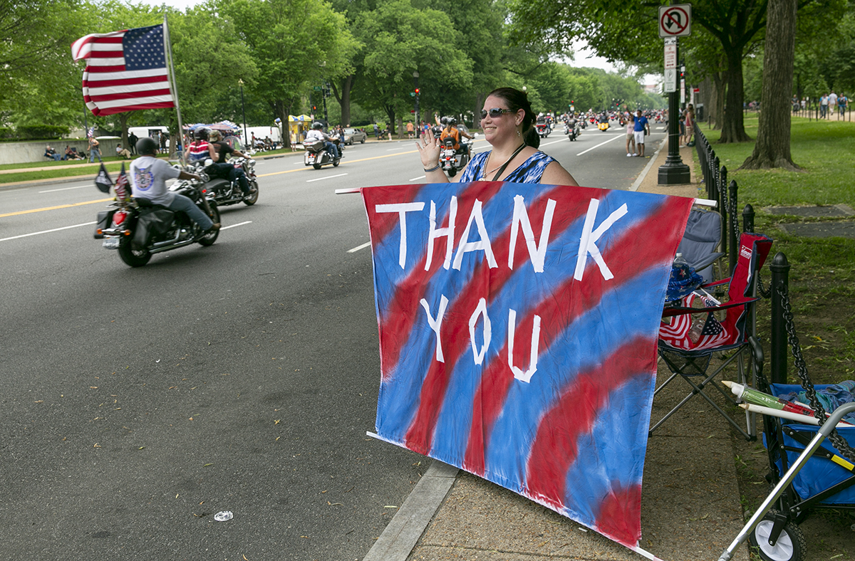 Susan McBride, from Maryland, thanks riders for their service during Rolling Thunder XXXI First Amendment Demonstration Run along Constitution Ave. in Washington, DC on Sunday May 27, 2018. Motorcycle riders from across the nation, rode a designated route through the Mall area of Washington, D.C. The event is an actual demonstration/protest to bring awareness and accountability for POWs and MIAs left behind.(Alan Lessig/Staff)