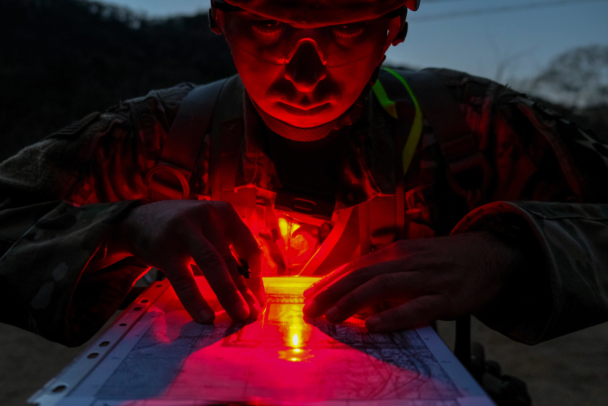 Army Staff Sgt. Symon Bowlen uses his red lens flashlight to plot points for night land navigation during the 2nd Infantry Division Best Warrior Competition at Camp Casey, Republic of Korea, April 17, 2019. (Capt. Daniel Parker/Army)