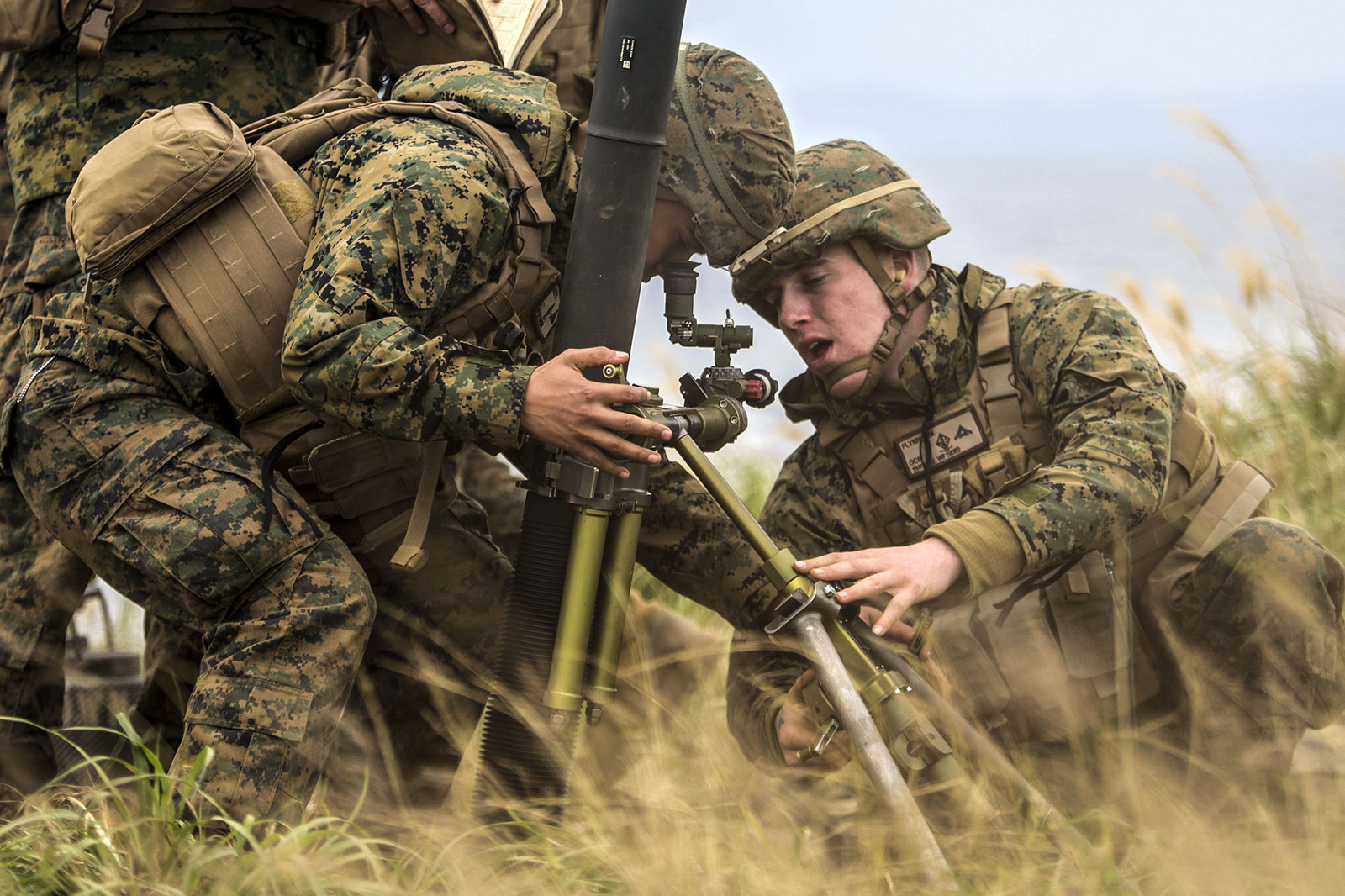 Marine Corps Lance Cpl. Felix Ruiz, left, and Marine Corps Lance Cpl. Devon Flynn, confirm the alignment of an 81mm mortar system at a range, Okinawa, on Dec. 21, 2017. (Cpl. Bernadette Wildes/Marine Corps)