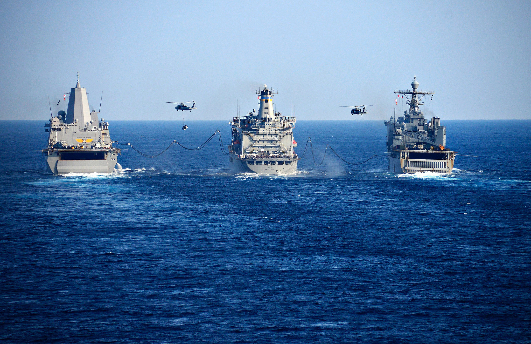 The transport dock ship USS Green Bay (LPD 20), the Military Sealift Command fleet replenishment oiler USNS Walter S. Diehl (T-AO 193), and the amphibious dock landing ship USS Ashland (LSD 48) conduct a replenishment-at-sea with MH-60S Seahawk helicopters on Jan. 30, 2019, in the Philippine Sea. (MC1 Daniel Barker/Navy)