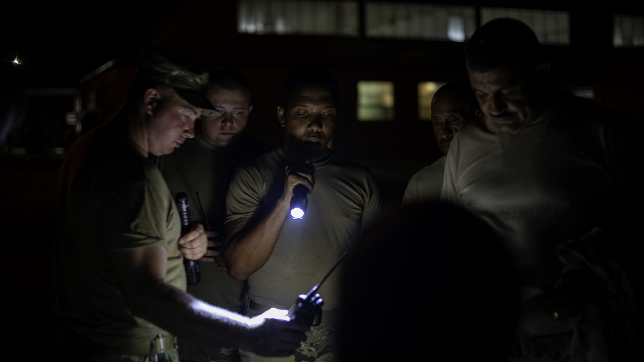 Staff Sgt. Robert Shook carries out radio checks Sept. 6, 2019, prior to transporting Light Medium Tactical Vehicles needed to cross flood waters in the Outer Banks of North Carolina. (Spc. Abraham Morlu/Army National Guard)