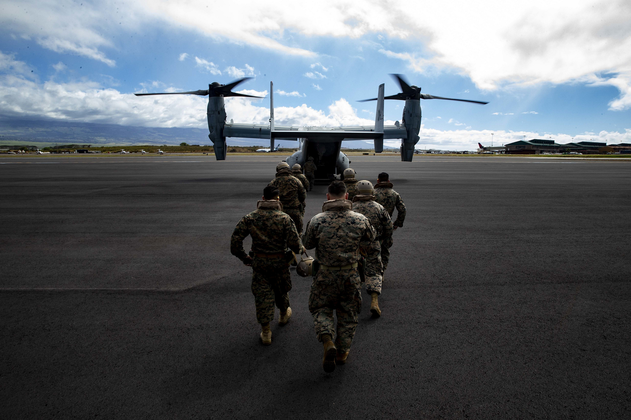 Reconnaissance Marines return to an MV-22B Osprey after transporting Marine Toys for Tots Donations from Marine Corps Base Hawaii to the Salvation Army Centers on the island of Maui, Dec. 20, 2018. (Sgt. Alex Kouns/Marine Corps)