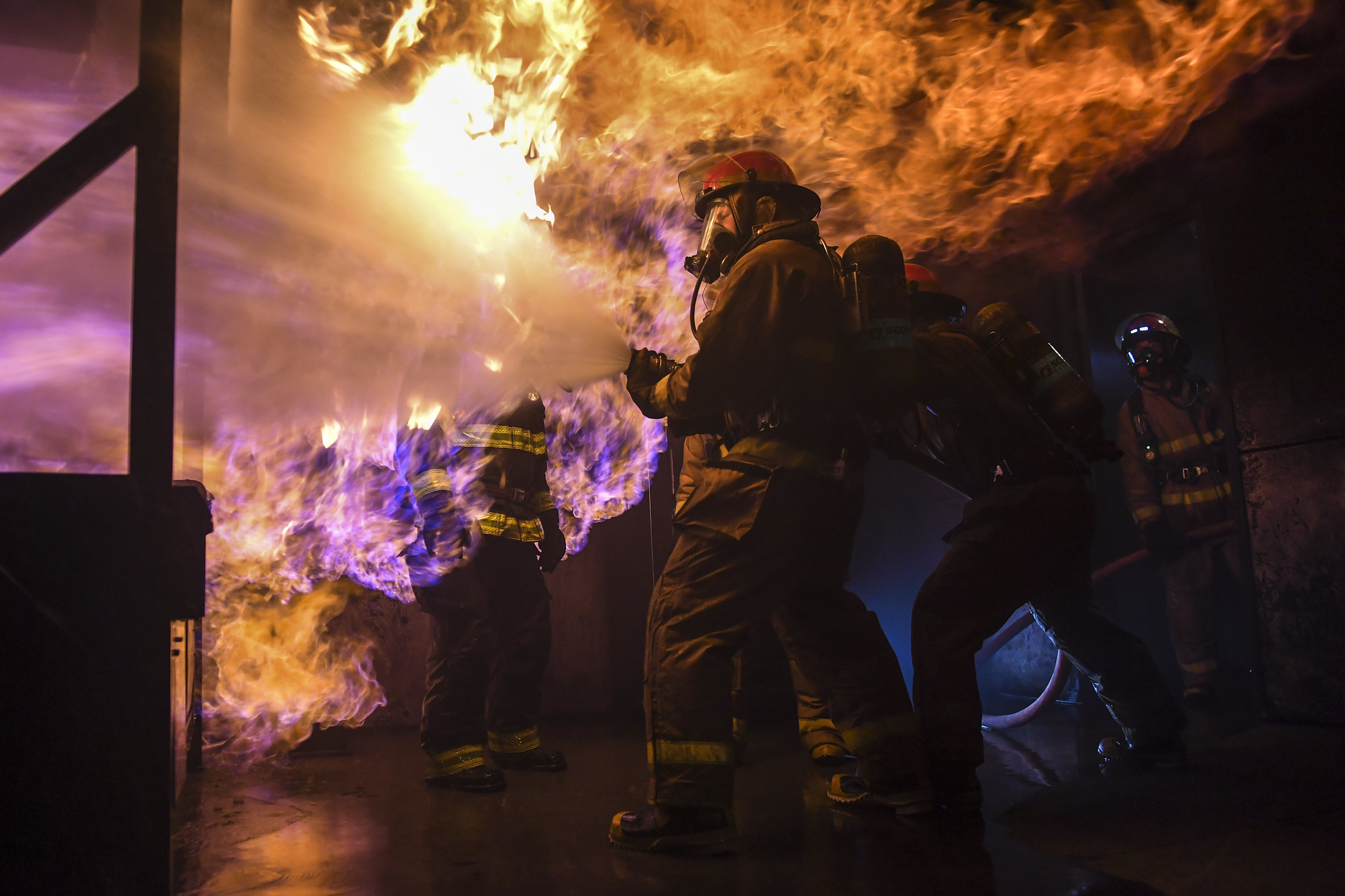Sailors assigned to the aircraft carrier USS Carl Vinson (CVN 70) and the Arleigh Burke-class guided-missile destroyer USS Grimley (DDG 101) practice firefighting skills and techniques on May 15, 2019, by battling a simulated fire at the Bremerton International Emergency Services Training Center (BIESTC) in Washington state. (Mass Communication Specialist 2nd Class Wyatt L. Anthony/Navy)