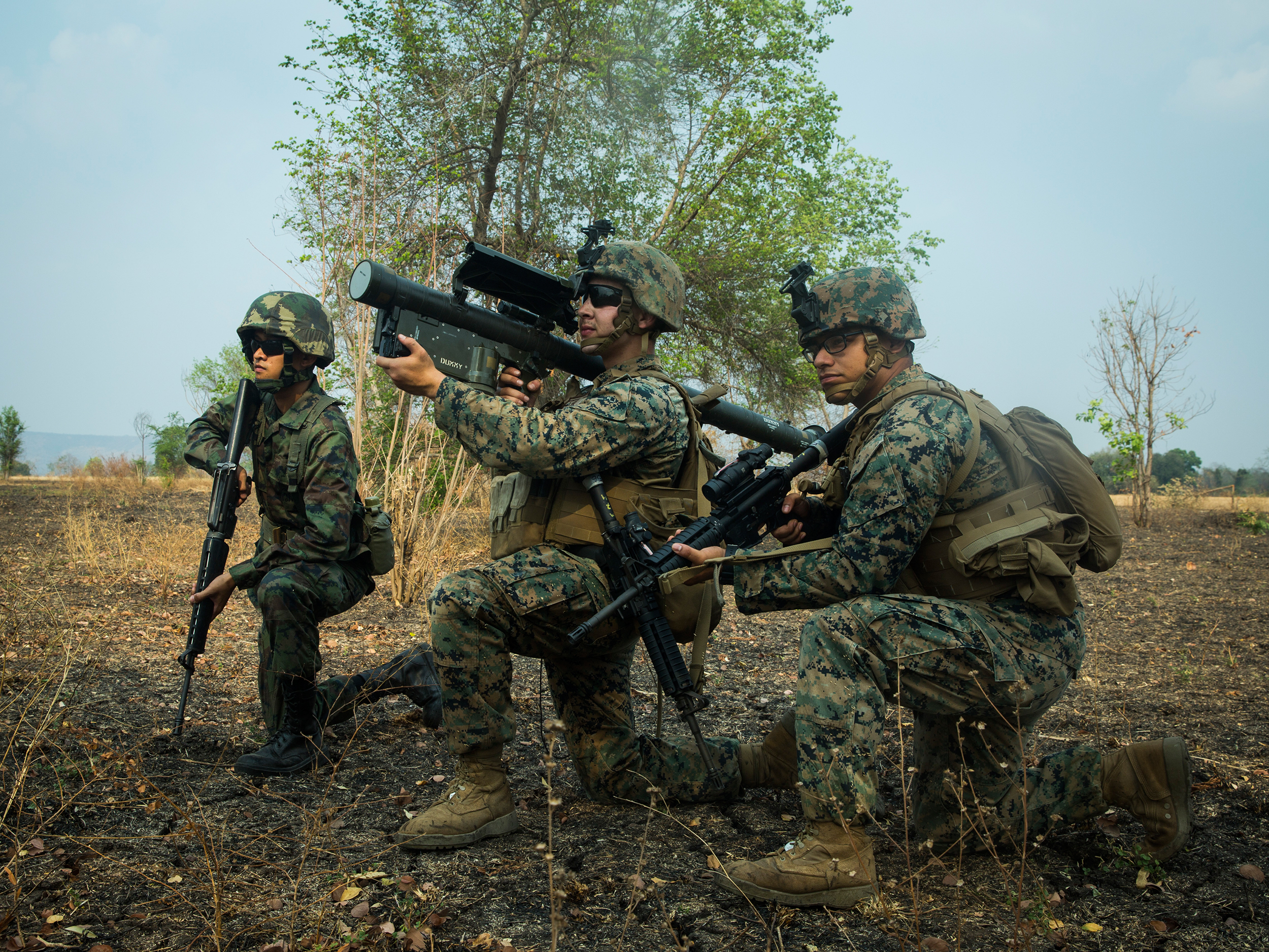 A U.S. Marine and Royal Thai Marine hold security as another Marine sights in with an FIM-92A Stinger missile launcher on March 2, 2020, during a combined joint High Mobility Rocket System rapid insertion as part of Cobra Gold 2020 at Chandy Range, Kingdom of Thailand. (Sgt. Audrey M. C. Rampton/Marine Corps)