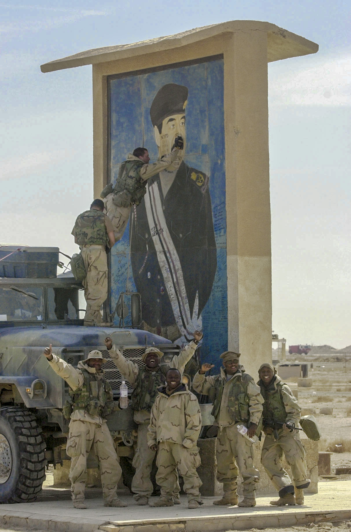 US. Army Soldiers from the 773 Transportation Company pulled their fuel tanker up to a large Saddam Icon so that they could write graffiti on the face. Several members of the company are New York Police and Firemen, and they had personal messages to write on the icon. This was located at Tallil air base in Southern Iraq. (Alan Lessig/Army Times)