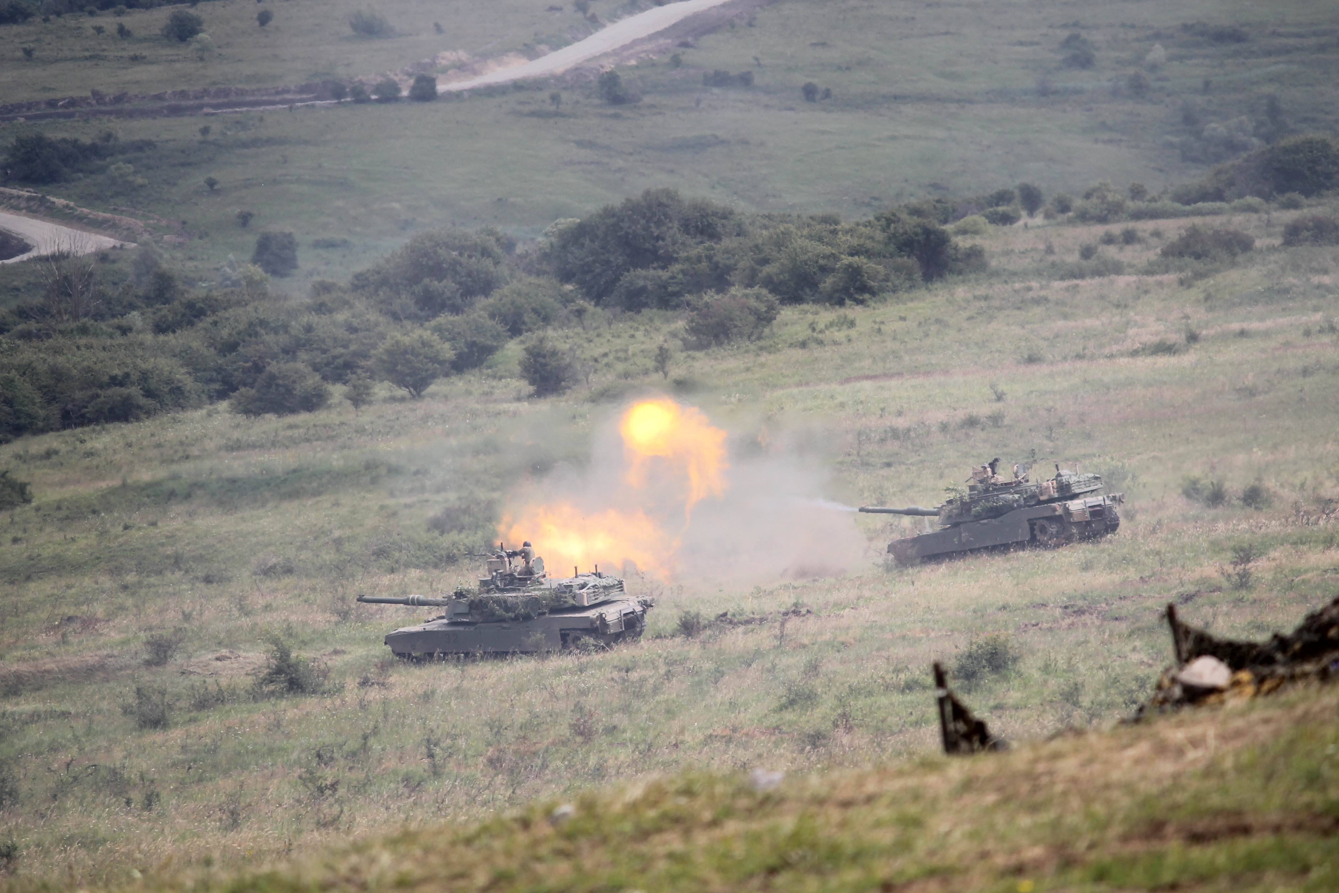A tank fires on the enemy as it’s forced to commit to its reserves. The multinational task force Iron Guardian’s commander positioned almost all weapon systems on the battlefield to deliver a large volley of fire power at once on the enemy target, completely obliterating the enemy’s reserves in the process. (Jen Judson/Staff)