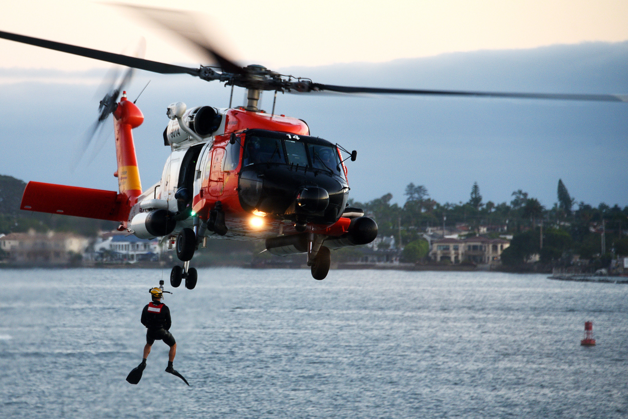 A U.S. Coast Guard Sector San Diego MH-60T Jayhawk helicopter crew conducts a search and rescue demonstration in San Diego, Aug. 10, 2019. (Petty Officer 1st Class Patrick Kelley/Coast Guard)
