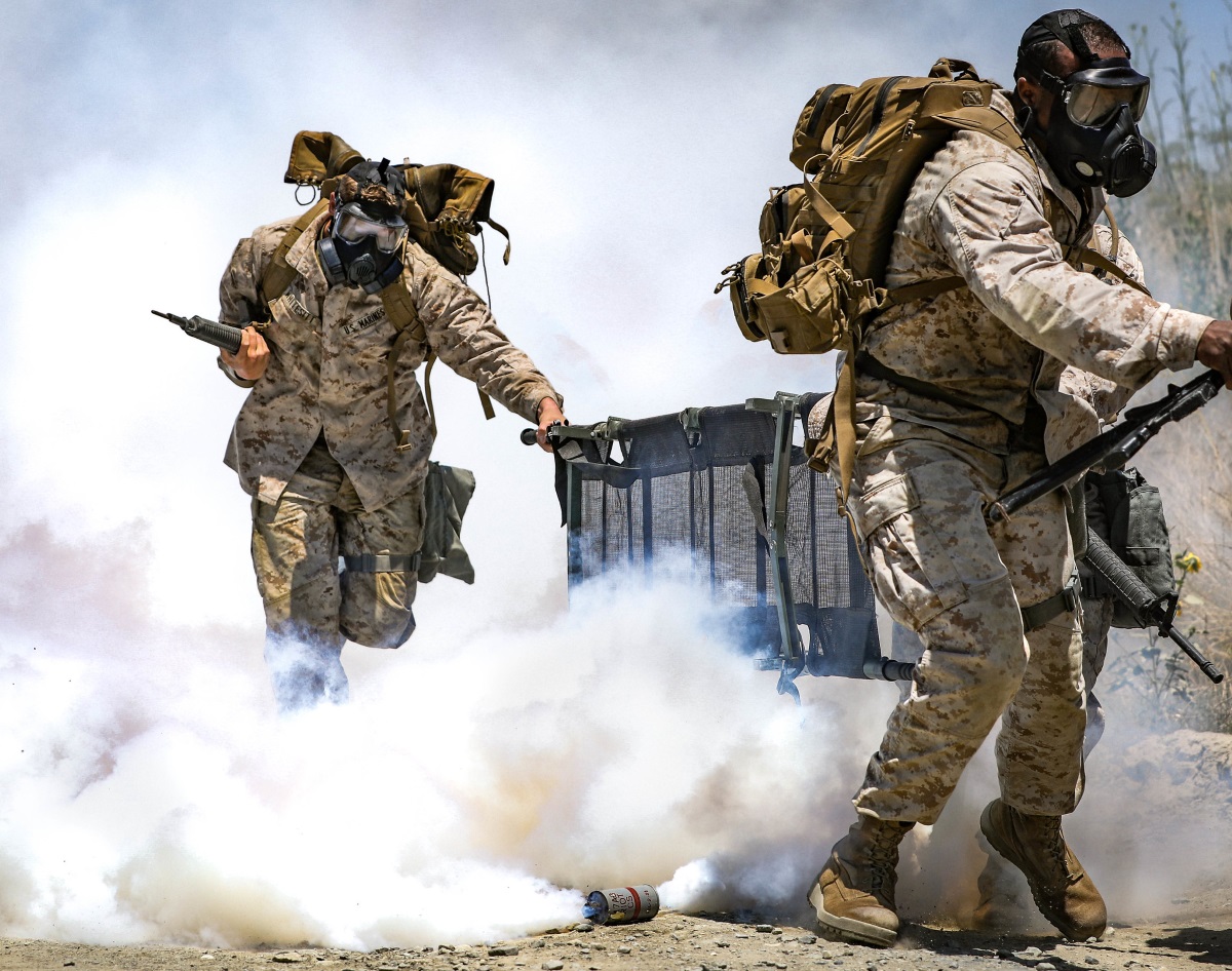 Marines run during a simulated chemical, biological, radioactive, and nuclear attack for the Command Sponsored Corporals Course at Marine Corps Base Camp Pendleton, Calif., June 19, 2019. (Lance Cpl. Alexa M. Hernandez/Marine Corps)
