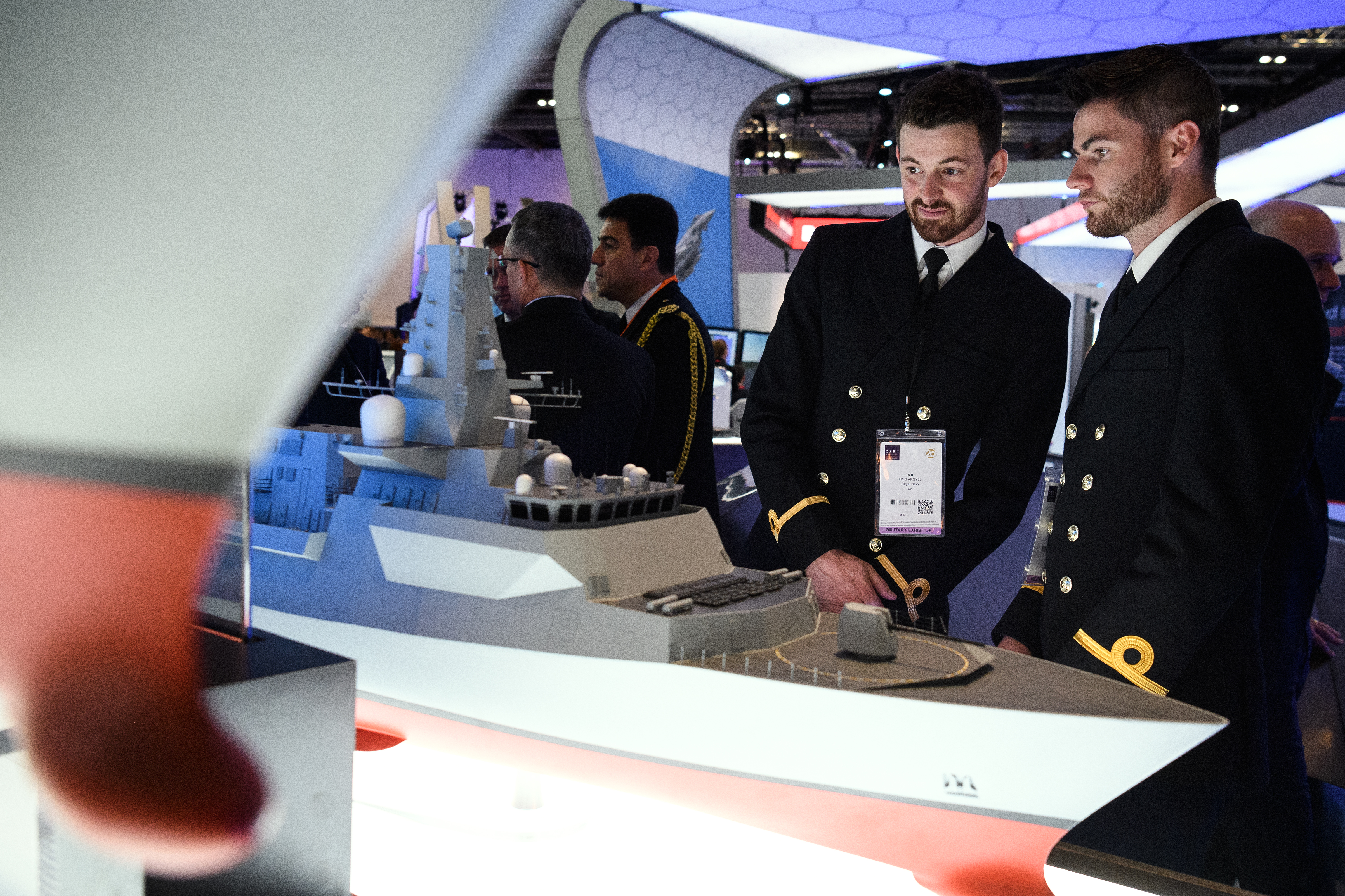 Two men look at a model of a Type 26 frigate at the BAE Systems stand at DSEI. (Leon Neal/Getty Images)