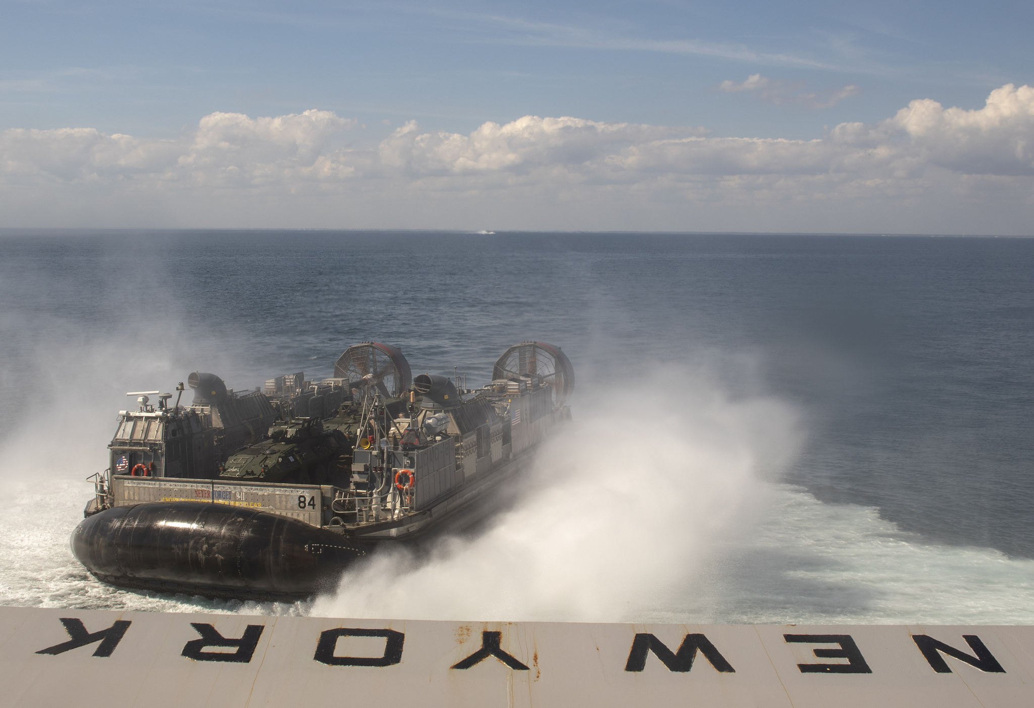 A landing craft, air cushion assigned to Assault Craft Unit (ACU) 4 leaves the well deck of the San Antonio-class amphibious transport dock ship USS New York (LPD 21), Oct. 3, 2018. New York departs Mayport, Fla., to participate in Trident Juncture 2018, a NATO-led exercise designed to certify NATO response forces and develop interoperability among participating NATO and partner nations. (MC2 Lyle Wilkie/Navy)