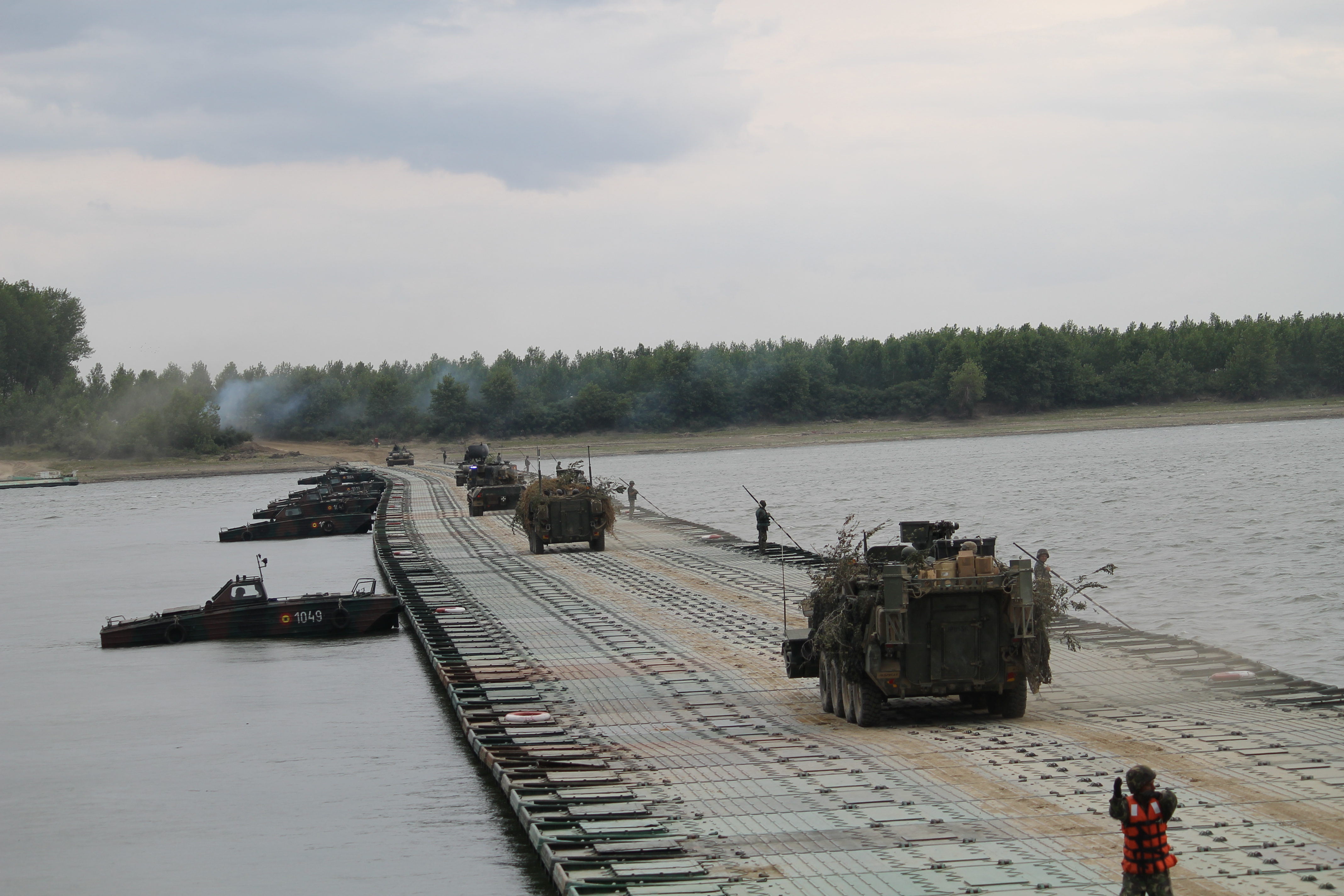 U.S. Strykers move slowly across the bridge to mark the end of the river crossing exercise. The U.S. Strykers of the 2nd Cavalry Regiment are often the vehicles of choice during bridging and river crossing exercises in Europe. U.S. Strykers crossed a bridge constructed using M3 amphibious vehicles In Chelmno, Poland, during the country’s major military exercise Anakonda 2016 in June, for example. (Jen Judson/Staff)