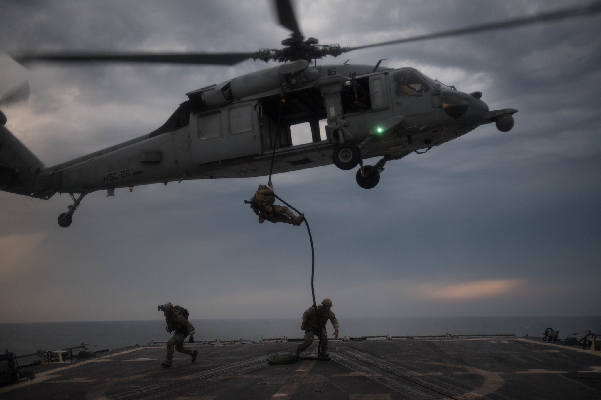 U.S. Coast Guard Maritime Security Reaction Team members rappel onto the flight deck of the guided-missile destroyer USS Chung-Hoon (DDG 93) from an MH-60S Sea Hawk on March 14, 2019, during an insertion training exercise in the Arabian Gulf. (Mass Communication Specialist 2nd Class Logan C. Kellums/Navy)