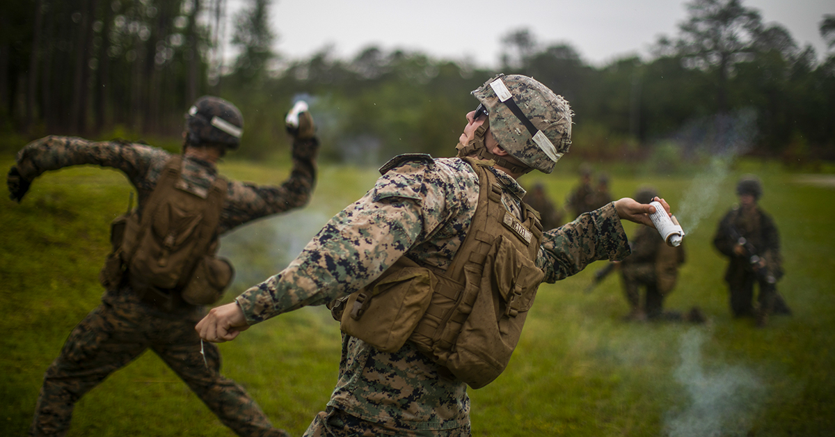 Marine Sgt. Nicholas R. Wetzel, a combat instructor assigned to Kilo Company, Marine Combat Training Battalion, School of Infantry-East, throws a ground burst projectile simulator C1A1 during a live fire and maneuver exercise at Camp Lejeune, North Carolina. (Sgt. James R. Skelton/Marines)