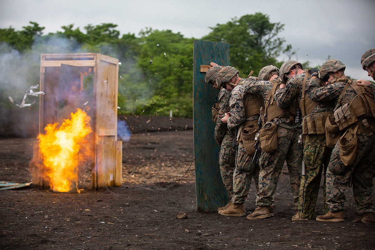 Marines stand behind a wooden shield during an urban-breaching range on Exercise Fuji Viper, at Combined Arms Training Center, Camp Fuji, June 11, 2019. (Lance Cpl. Joshua Sechser/Marine Corps)
