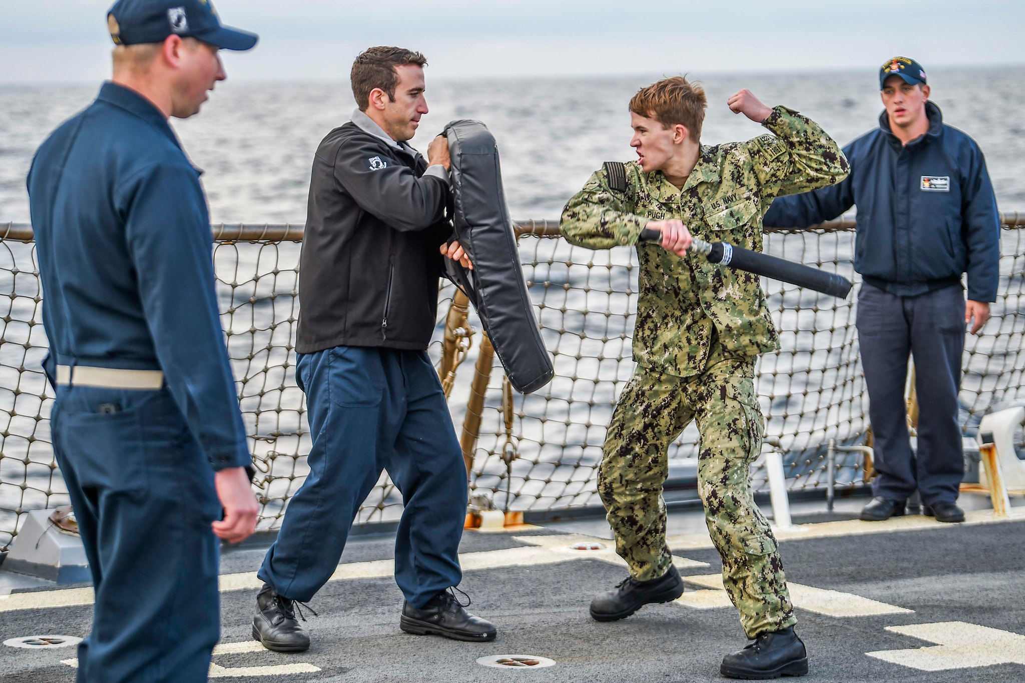 Electronics Technician 3rd Class Philip Pugh participates in a non-lethal weapons and oleoresin capsicum spray training course on the flight deck of the Arleigh Burke-class guided-missile destroyer USS Milius (DDG 69) on Dec. 30, 2019, in the Sea of Japan. (Mass Communication Specialist 2nd Class Taylor DiMartino/Navy)