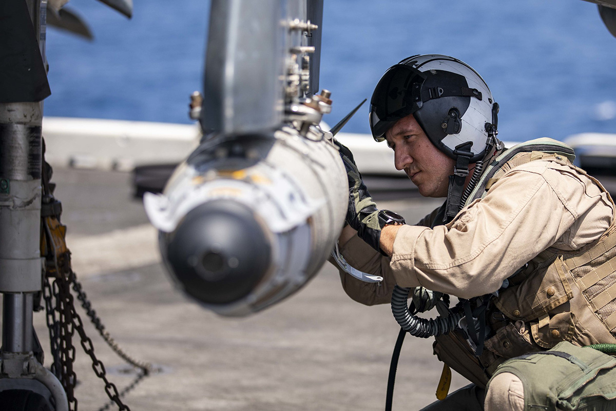 AV-8HB Harrier pilot Maj. Joseph Swindell inspects a GBU-54 joint direct attack munition during pre-flight checks May 20, 2019, on the flight deck of the Wasp-class amphibious assault ship USS Kearsarge (LHD 3) in the Arabian Sea. (Mass Communication Specialist 2nd Class Ryre Arciaga/Navy)