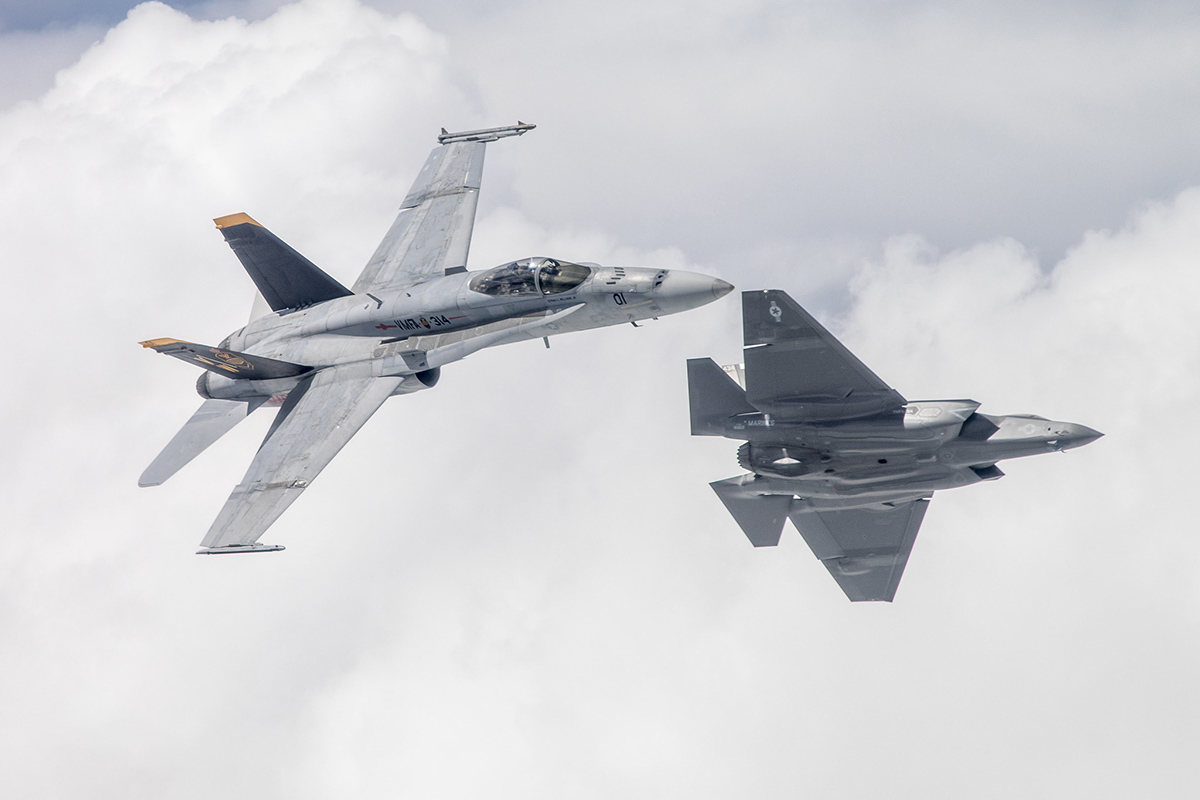 Capt. Tommy Beau Locke flies the first F-35C aircraft attached to the Black Knights of Marine Fighter Attack Squadron 314 over Naval Air Station Lemoore, Calif., in formation with an F/A-18A flown by Lt. Col. Cedar Hinton while